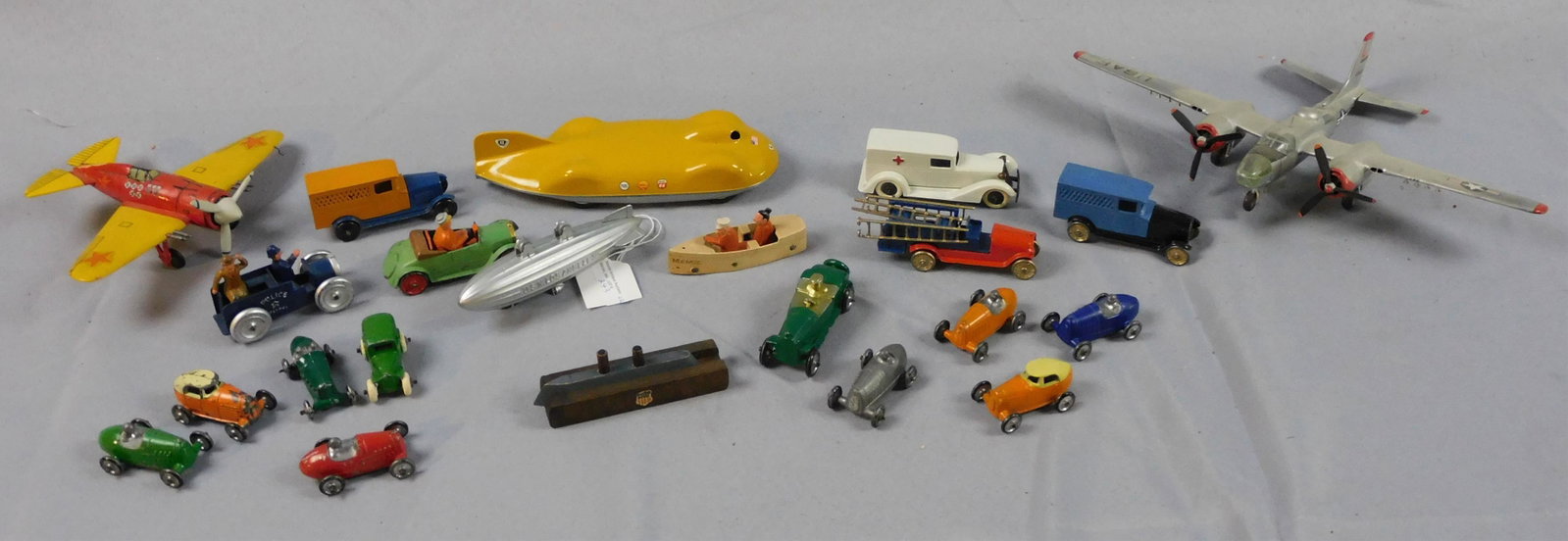 (22) miniature toys, ca. mid 20th c. To include:: Penco 1947 CO2 control line, near mint condition, missing its CO2 cartridge, 7 1/2" long. 8 Tootsietoys to include: Aunt Mamie boat (3 1/4" long), police patrol wagon, a fire truck with ladders, a Zep