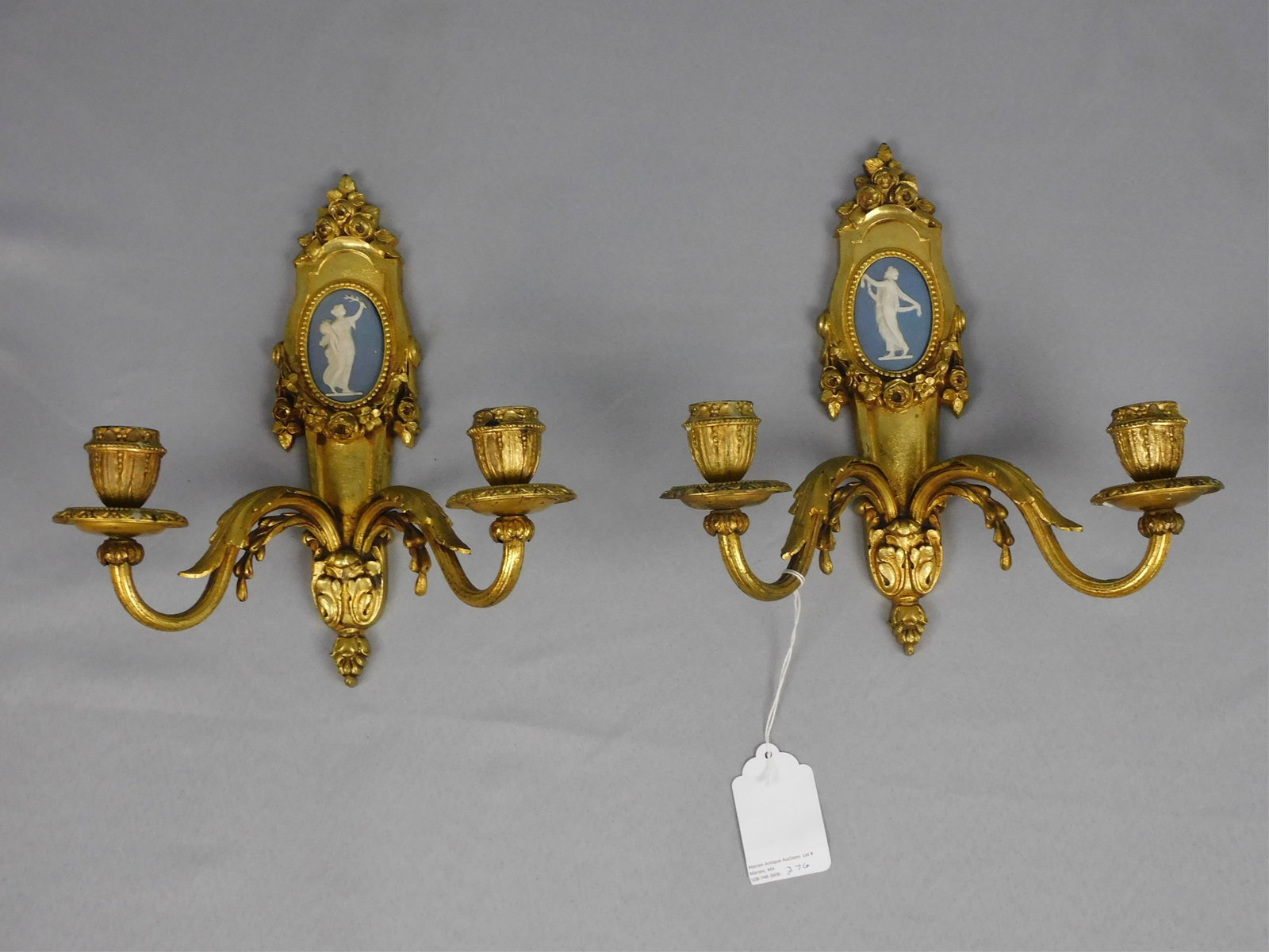Pair of continental sconces. Early 20th c., two: branches, gilded finish. Inset Wedgwood jasperware oval plaques. Ornate floral trim. 11 1/2" high, 11" wide, 5 1/4" deep. Good, original condition.