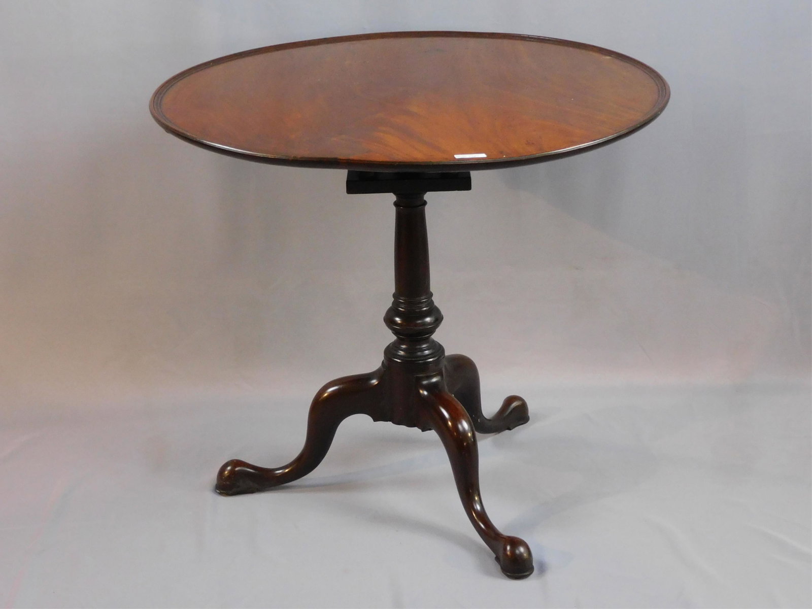 Chippendale tip top tea table, 18th c. American,: mahogany. 1740-1780. Possibly Philadelphia. Single board mahogany top, shows appropriate shrinkage. Dish top, birdcage platform. Turned wooden shaft supported by bulbous Queen Anne style feet. 30" hig