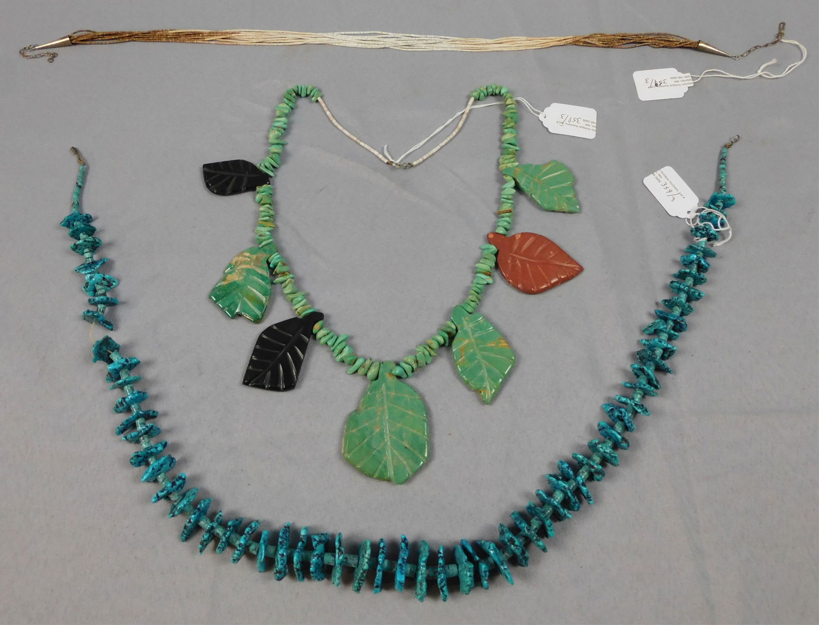 (3) Native American Necklaces. 20th century. To: include a Kingman turquoise nugget necklace 32" length. Good condition. Turquoise and heishi necklace with stone leaves. 28" length. Good condition. Heishi necklace 26" length. Good condition.
