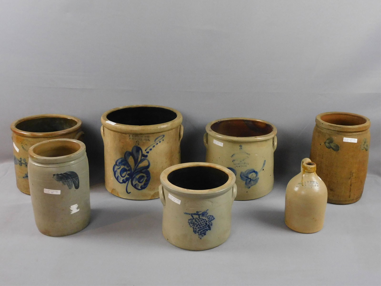 (7) American stoneware ceramics, 19th c. To: include: a half gallon crock, blue feather design, 10" high, 6" diameter, chip to rim. Another FB Norton and Co, Worcester, 3 gallon crock, with bold floral design, 10 1/2" high, 11" diameter, has two