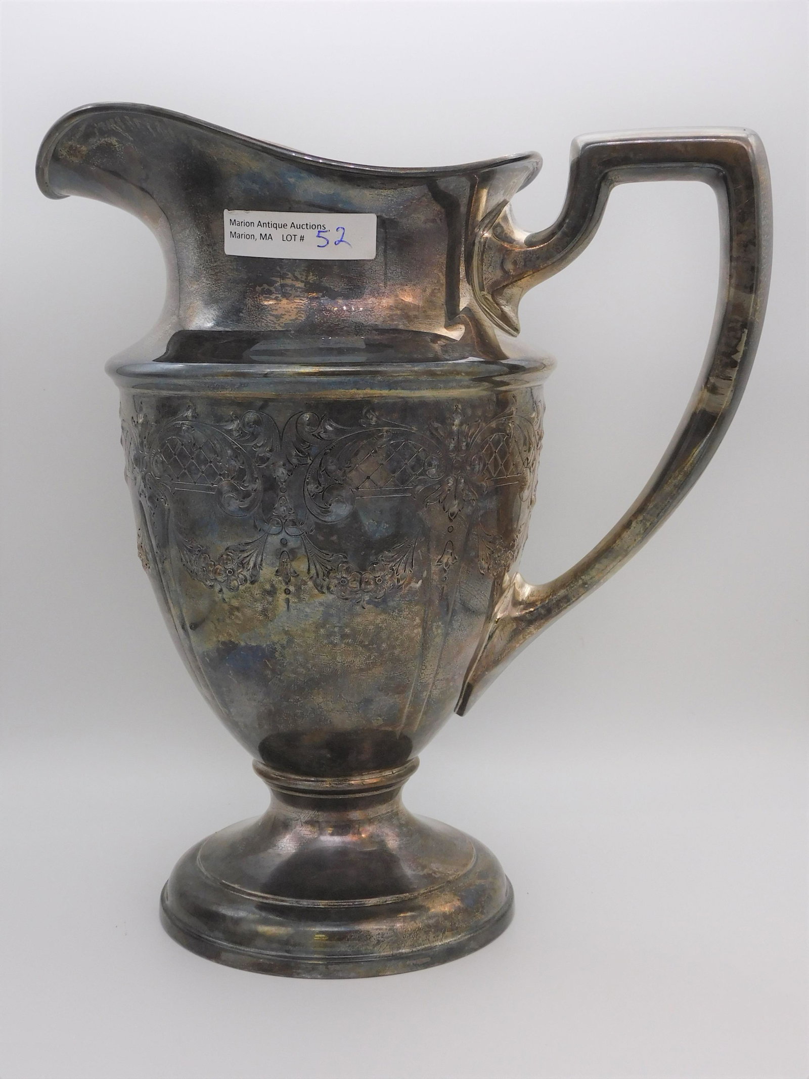 Sterling silver pitcher, hand chased floral: design. Marked ACSME. 10" high, 8 3/4" wide, 5 1/2" diameter. 33.14 ozt.
