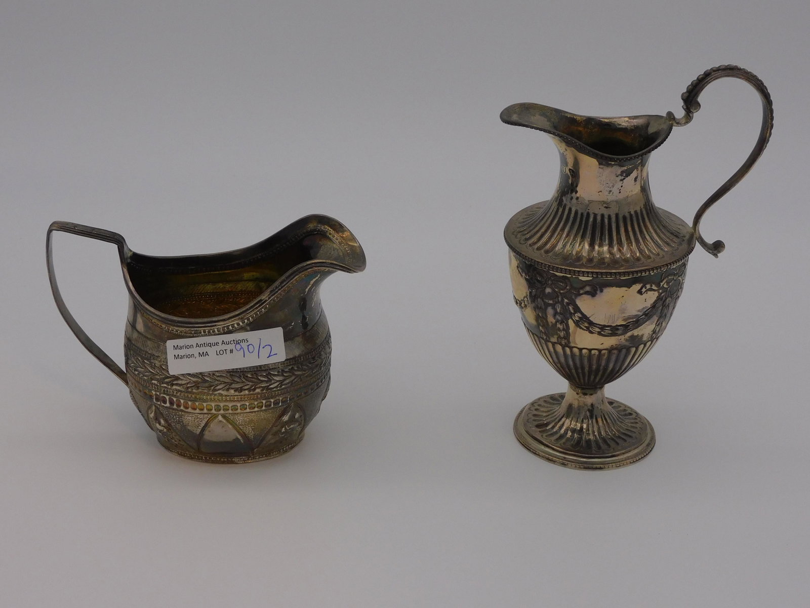 (2) English silver handled creamers, 19th c. to: include: a Regency urn shaped creamer, 1817, believed to be Jason Lloyd, 6 1/4" high, 3 3/4" wide, 2 3/4" diameter. Along with an embossed and hammered creamer, 1808, makers mark IM, 3 1/2" high, 4 3/
