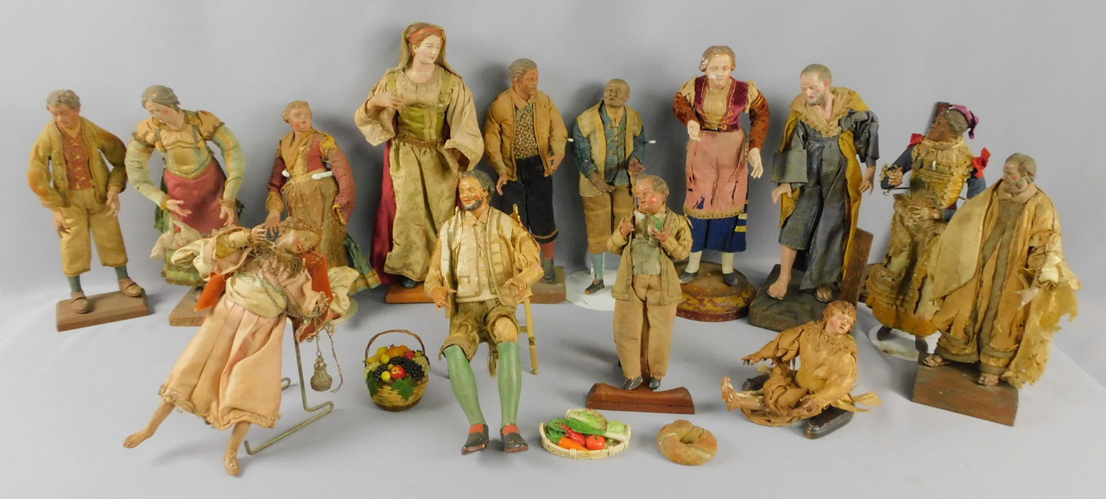 (15) Italian Neapolitan presepio creche figures,: late 18th and 19th centuries. Comprising an array of male and female figures of various ages and ethnicities, primarily local villagers, one angel. Ranging in height from 8" to 12 1/2". Some showing p