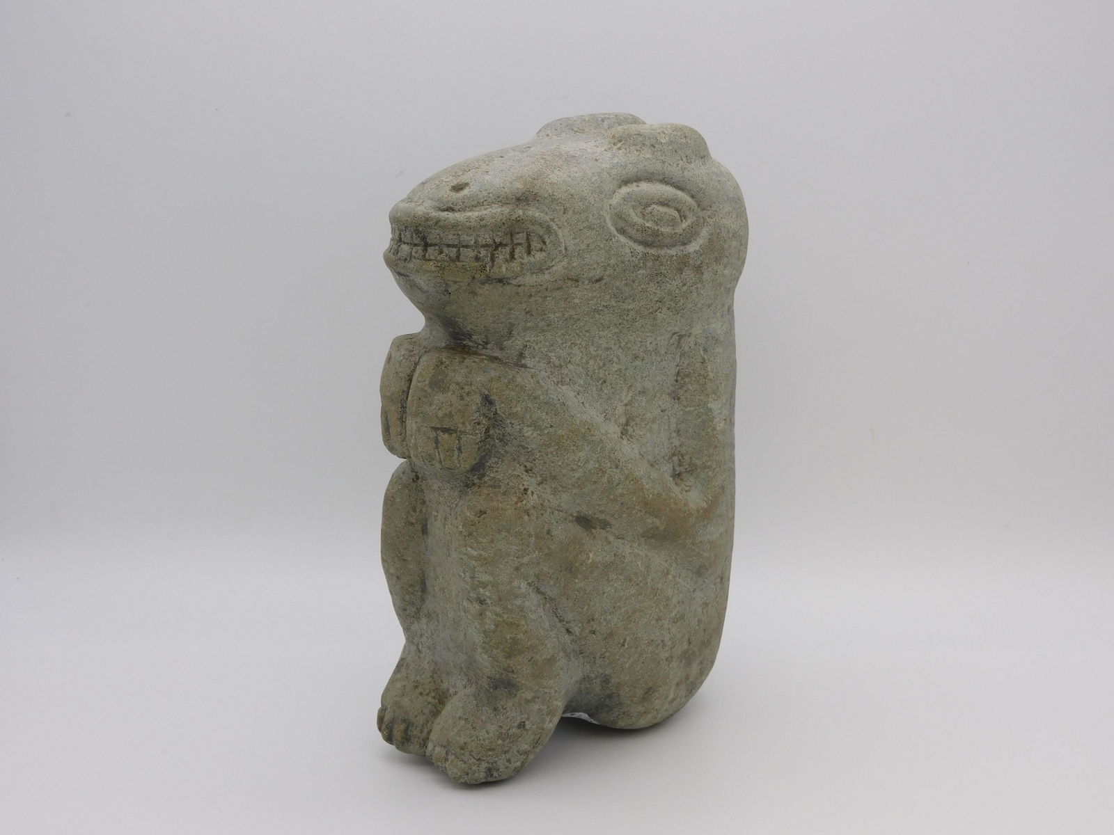 Taino, simple dog sculpture, two nubs: representing ears, as well as ovate eyes and full dental display. The dog appears to be begging. Most sculptures originating in Haiti were not as elaborate as those from the Dominican Republic and wer