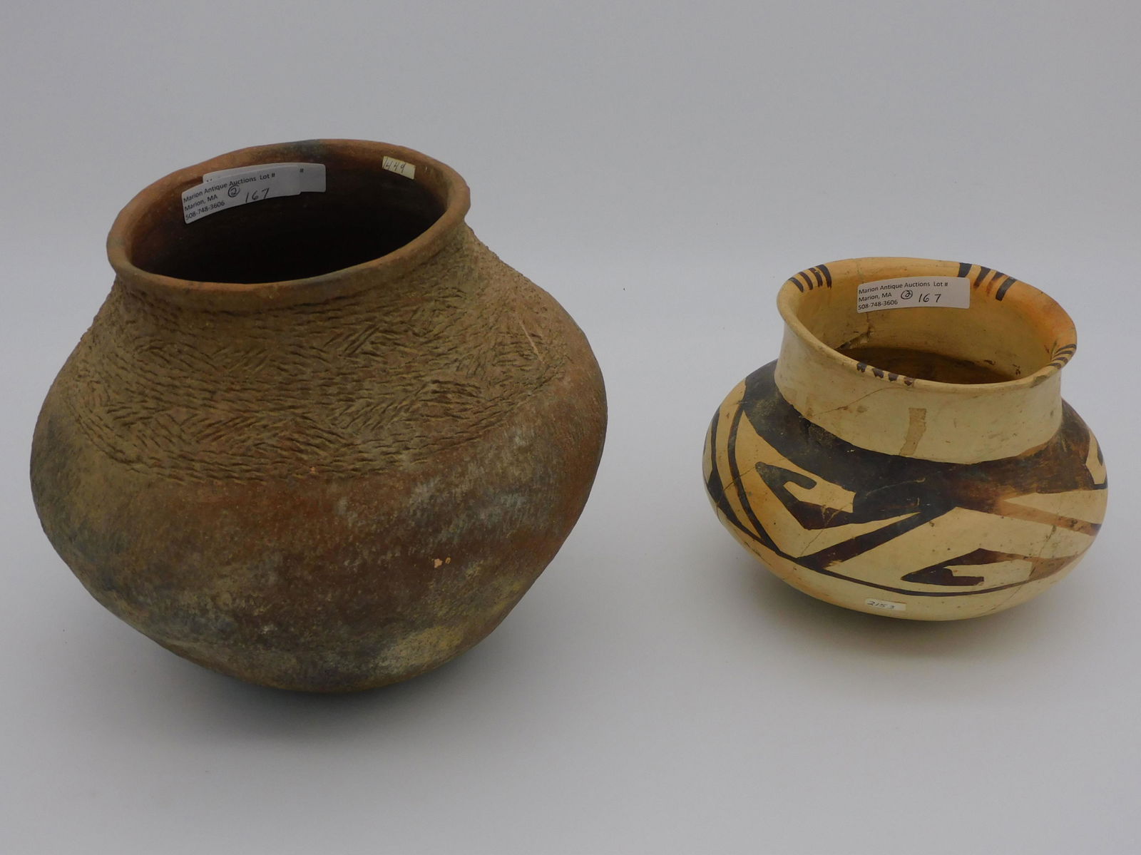 Early Southwest Pueblo ancestral redware pottery: olla. Primitive incised geometric design. 7" high, 8" diameter. Overall good condition. Along with another Pueblo ancestral olla, geometric designs, 5" high, 6" diameter, shows complete reconstruction