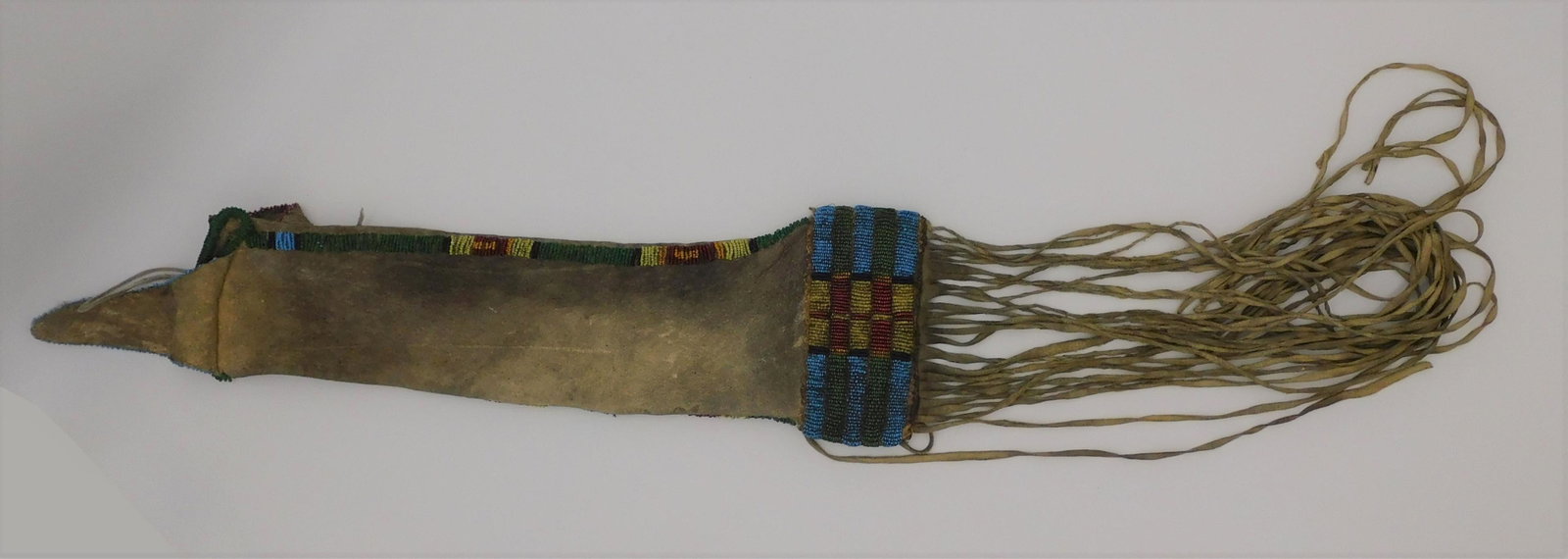 Cheyenne tobacco beaded bag, buffalo hide panel,: restored fringe. Geometric multicolored beading. 17" long, 5 1/2" wide overall.