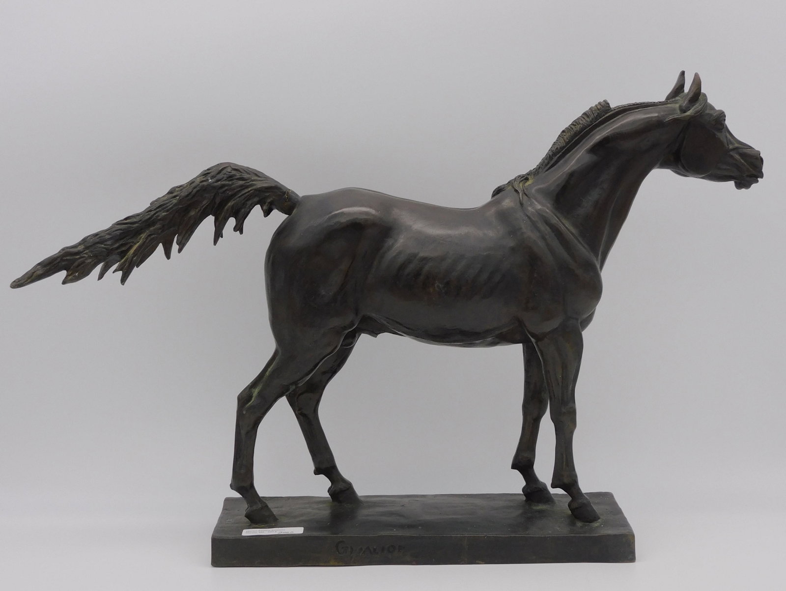 Bronze sculpture of a horse, late 20th c. Signed: Gwalior. Signed on base and monogrammed G in a triangle, dated 1970. 14" high, 21 1/2" long, 4 1/4" wide. Tail shows separation.