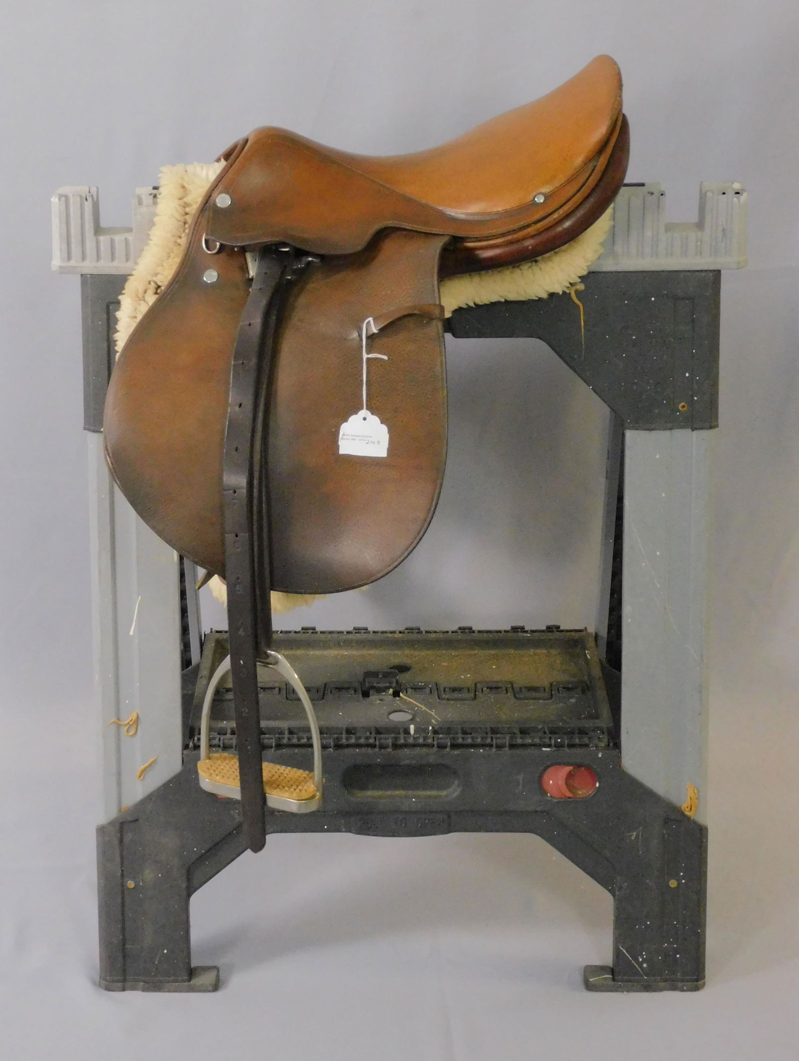 Hermes horse saddle, with straps and stirrups.: Mid 20th c. Brown leather, chrome buttons signed "Hermes Paris". Also stamped "SGDG Hermes" in the leather. Chrome stirrups with hard rubber foot rests. Original leather straps. Leather is also stampe