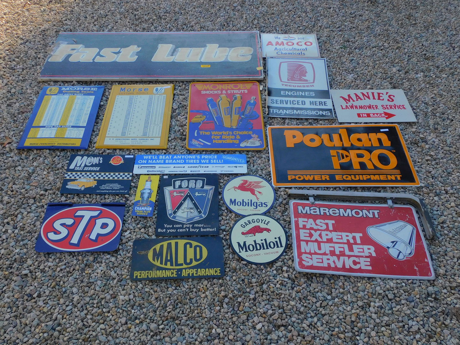 (17) vintage automotive and tool signs, to: include: Fast Lube, Monroe Shocks, Name Brand Tires, Champion Spark Plugs, Ford, Mobil Gas, Mobil Oil, Malco, Mom's Taxi Service (repro), STP, two Morse Cutting Tools signs, Poulan Power equipment, Ma