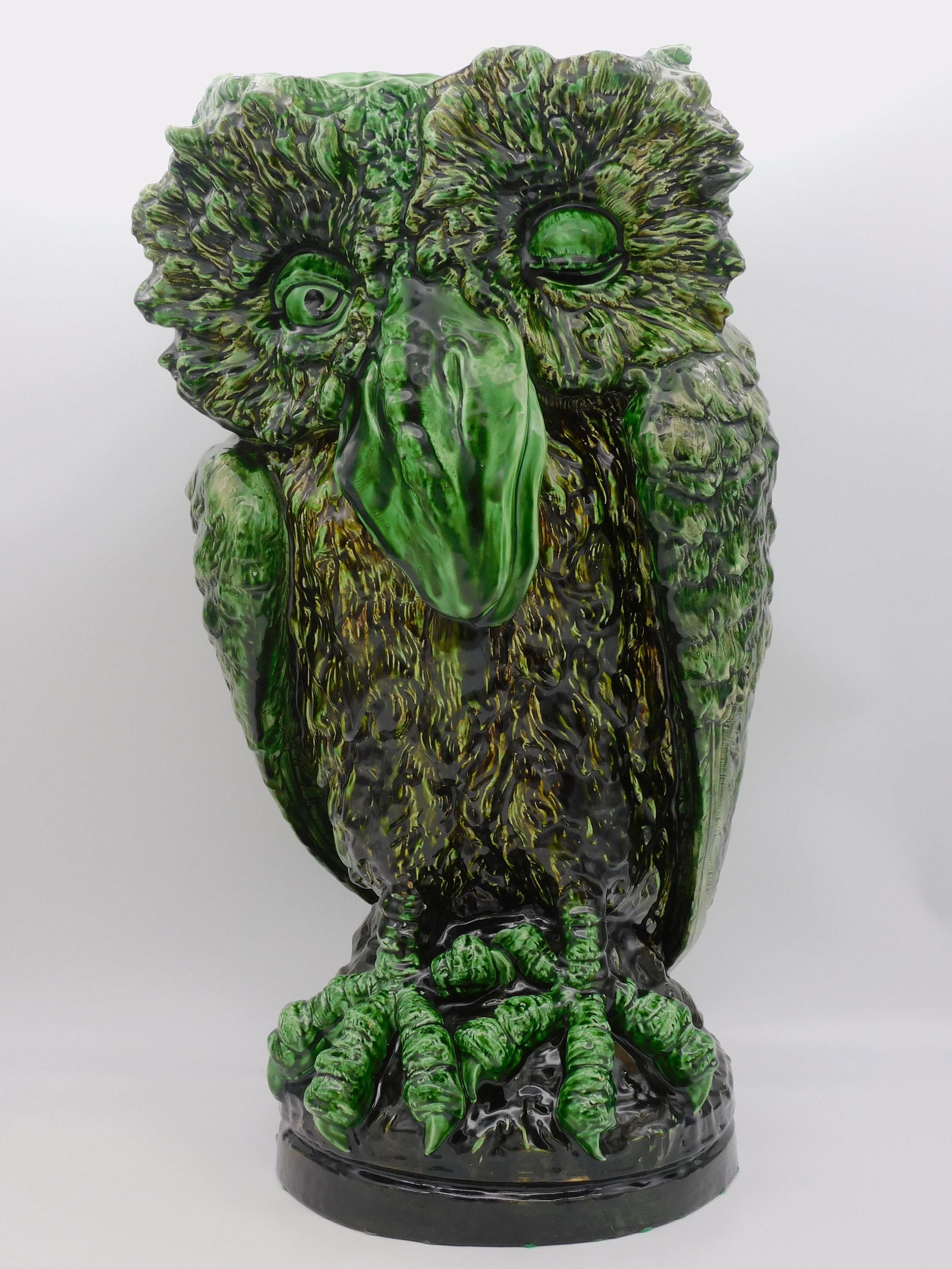 Ernst Wahliss (1837-1900, Austria) green glazed: earthenware owl form umbrella stand. "Made in Austria, Ernst Wahliss Turn Wien". #6297 artist stamp. 24 1/2" high, approx. 11" diameter. Shows a very small crack to the rim.
