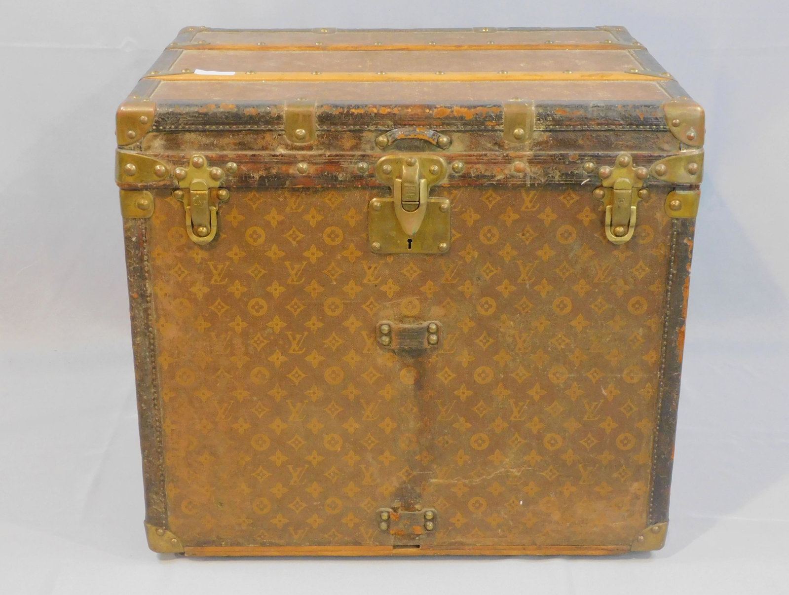 Louis Vuitton trunk, #15258, Paris, original: label. Late 19th/early 20th c. Also marked on lock, handles, latches. Original canvas covering with LV monogram. 21 1/2" high, 24" wide, 18 1/2" deep. The bottom portion of the interior is missing its