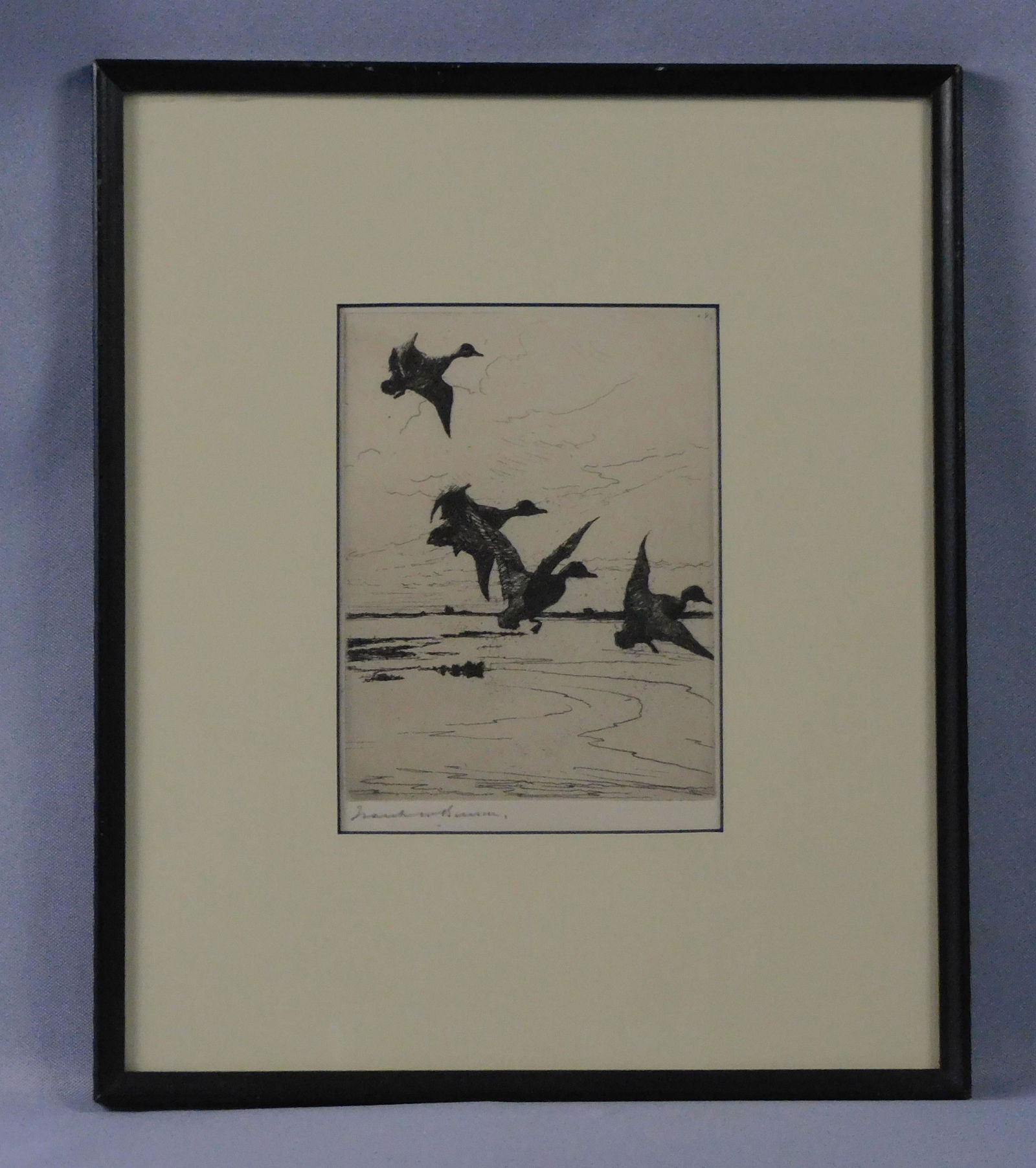 Frank Benson (1862-1951, MA) framed and: glazed etching depicting ducks in flight. Signed in pencil lower left. Sight size 6 1/2" x 4 1/2", overall in black wooden frame and UV glass 12 1/2" x 10 1/2".