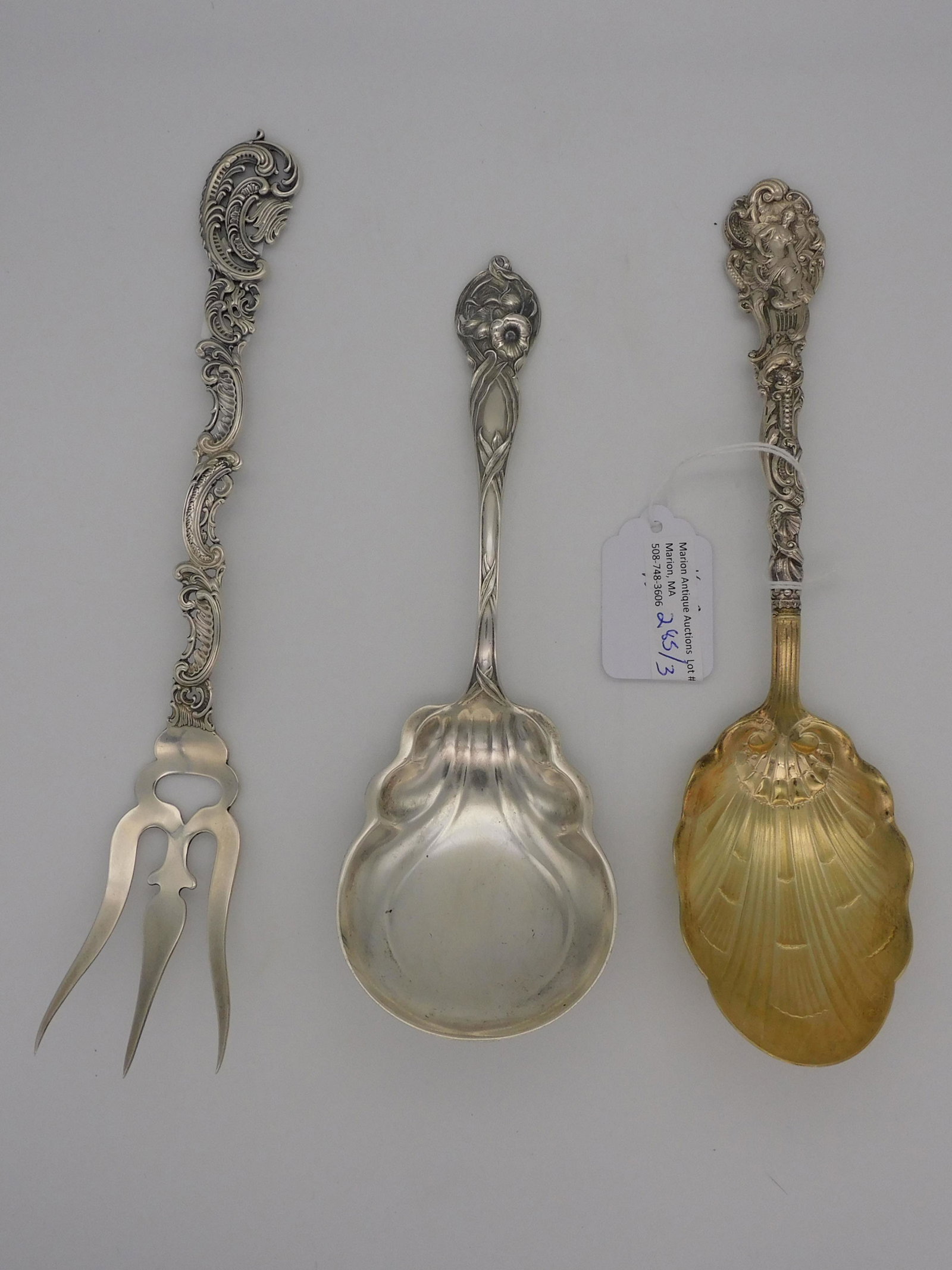 (3) ornate sterling silver serving pieces. To: include: Gorham Versailles pattern shell shaped serving spoon, 8 3/4" long, gold wash bowl. A meat fork, no maker's mark, 9 1/2" long, with scrolling design. Watson Co. shaped serving spoon, Orchid pa