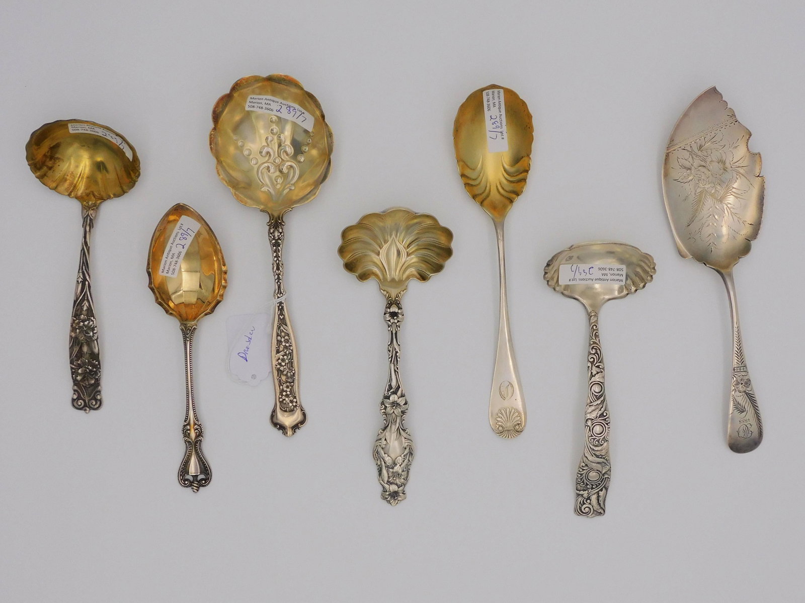 (7) sterling silver serving pieces, to include:: Whiting Lily pattern ladle, 7" long. A. Stowell marked ladle, 7" long, foliate and scroll design. Whiting, 7" long ladle, with ornate repousse floral design, gold wash bowl, monogrammed. Whiting Dresd