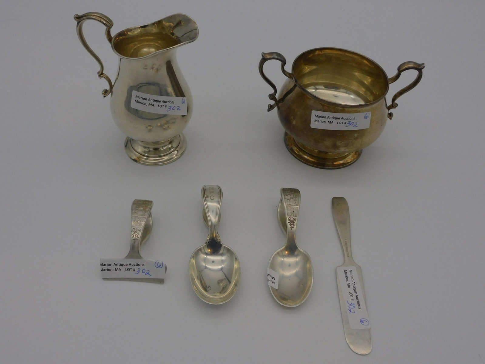 (6) pieces of Tiffany & Co. sterling silver, to: include: two baby spoons, one with an image of Little Bo Peep, the other with engraved HC monogram, 3 1/2" - 3 3/4" long. Hot Cross Buns design food pusher, 2 1/4" long. "Ride a Cock Horse" baby knife