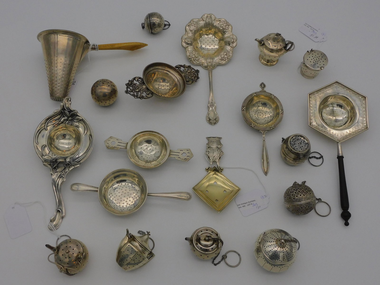 (19) sterling silver tea strainers and balls. To: include tea strainers by makers such as Wallace, Shreve Crump and Low, Towle, Whiting, Birks, Merrill, and others without maker's marks, 4 1/4" to 8" long. Along with tea infusers: four teapot form (a