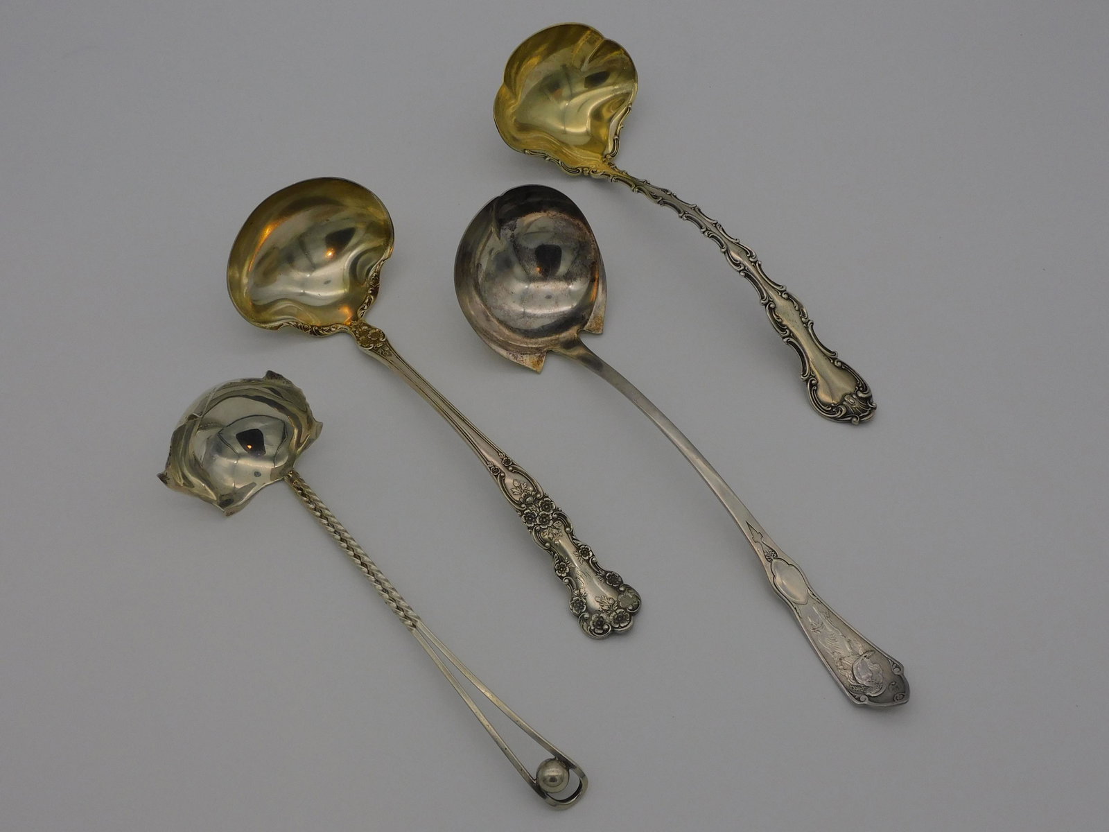 (4) sterling silver ladles, to include: Reed and: Barton, Pearl pattern, 12" long. Gorham, Buttercup pattern, 11" long. Gorham, Strasbourg pattern, 11" long. Sciarrotta, leaf form bowl, 9 1/2" long. 18.10 total ozt.