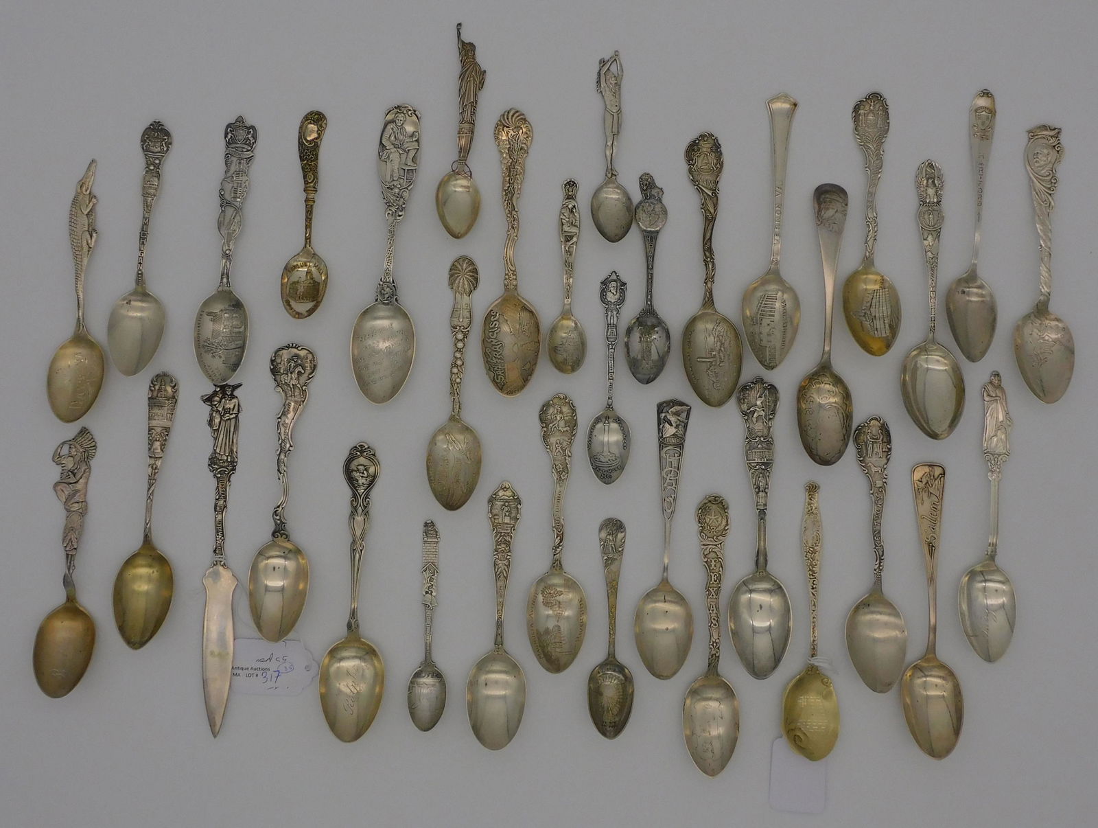 (34) sterling silver souvenir spoons (including: one letter opener), to include: state spoons such as Kentucky, Bath (ME) with figural native American, Daytona (FL) with alligator handle, Statue of Liberty, El Paso (TX), Christopher Columbus, Lake G