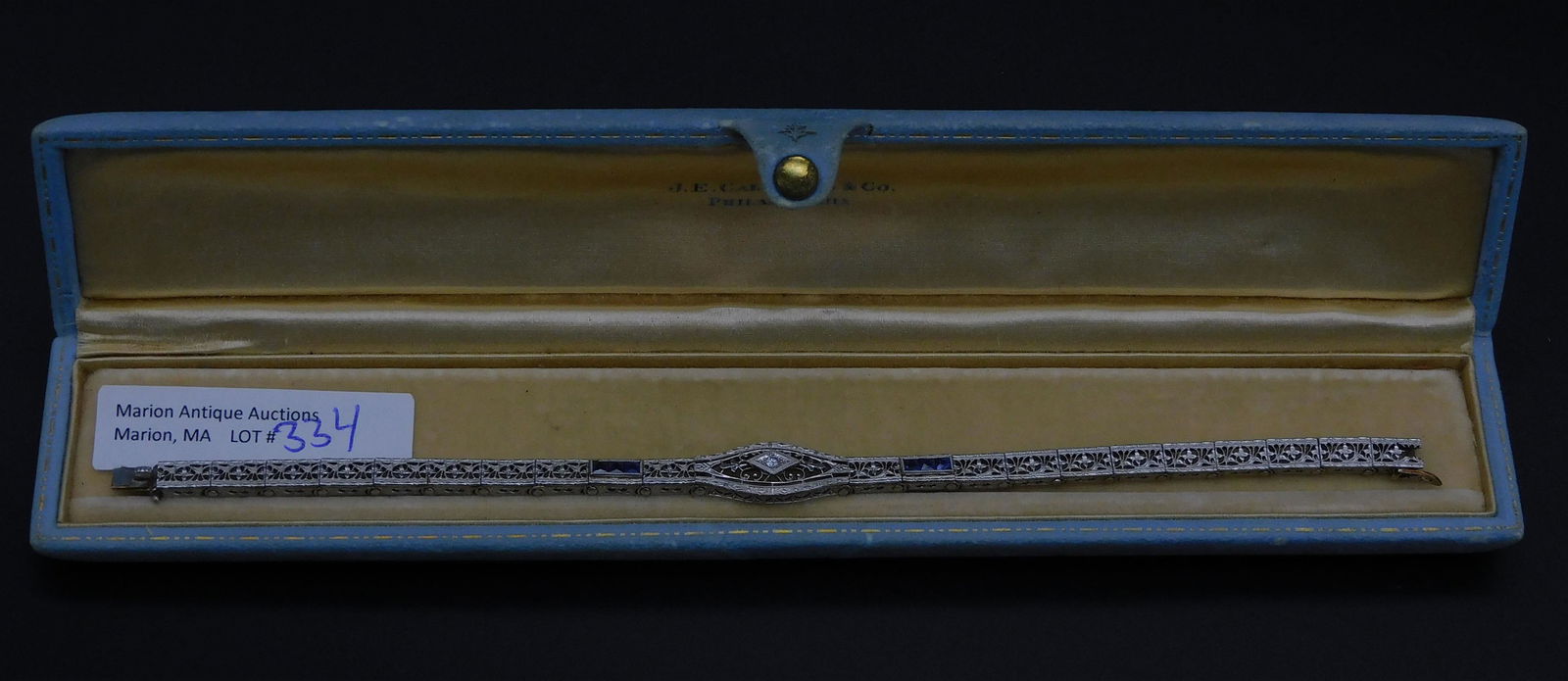 14kt gold art deco ladies bracelet set with: diamonds and sapphires. 7" long. Scrolling openwork design. 7.8 dwt. In the original Caldwell Co. Philadelphia box.