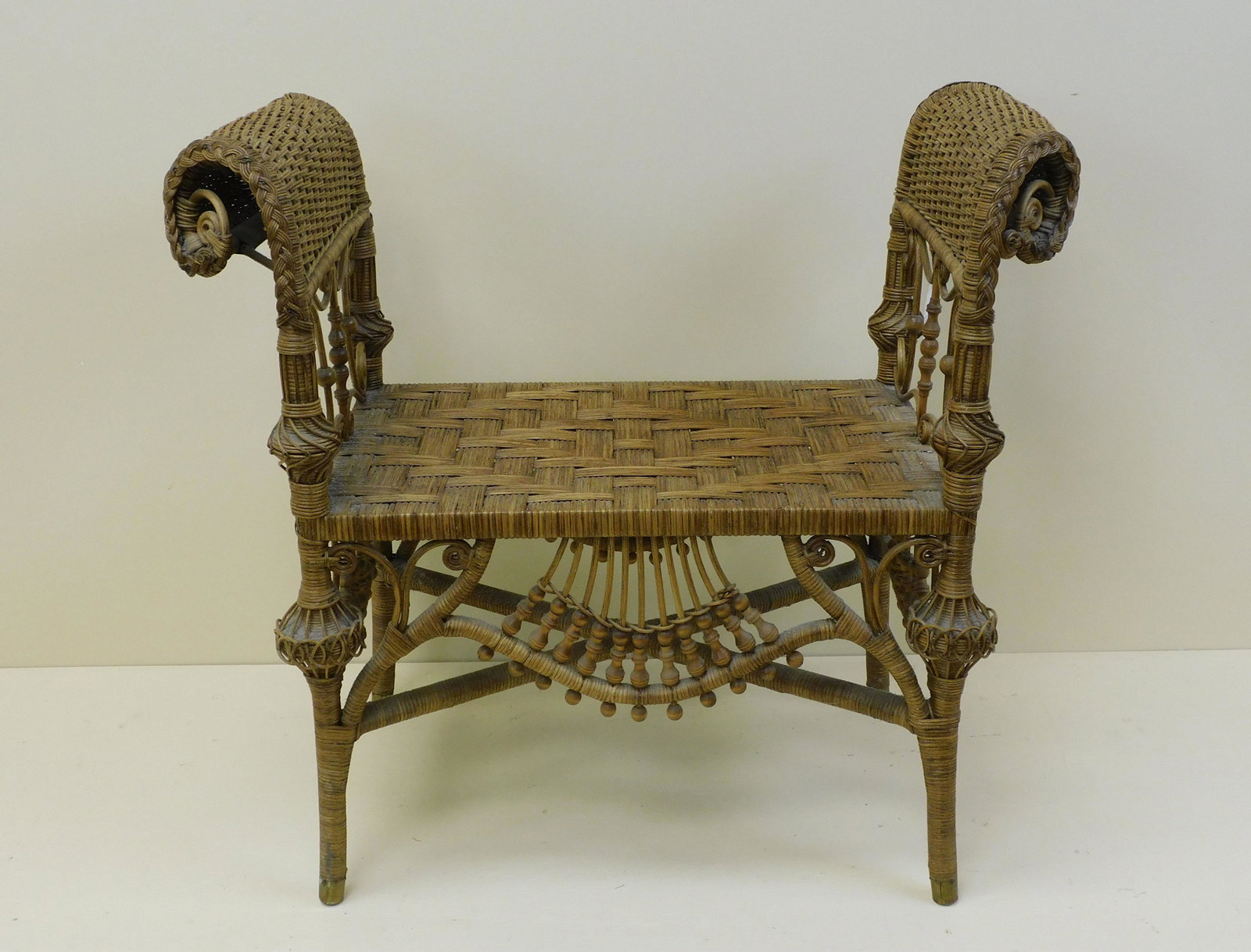 Victorian wicker Turkish bench, late 19th c. The: bench is made by an unknown maker. Natural finish and curlicued design. Elaborate beadwork. 30" high, 33" wide, 15" deep. 17" seat height. Excellent condition. Provenance: Mary Jean McLaughlin Collect