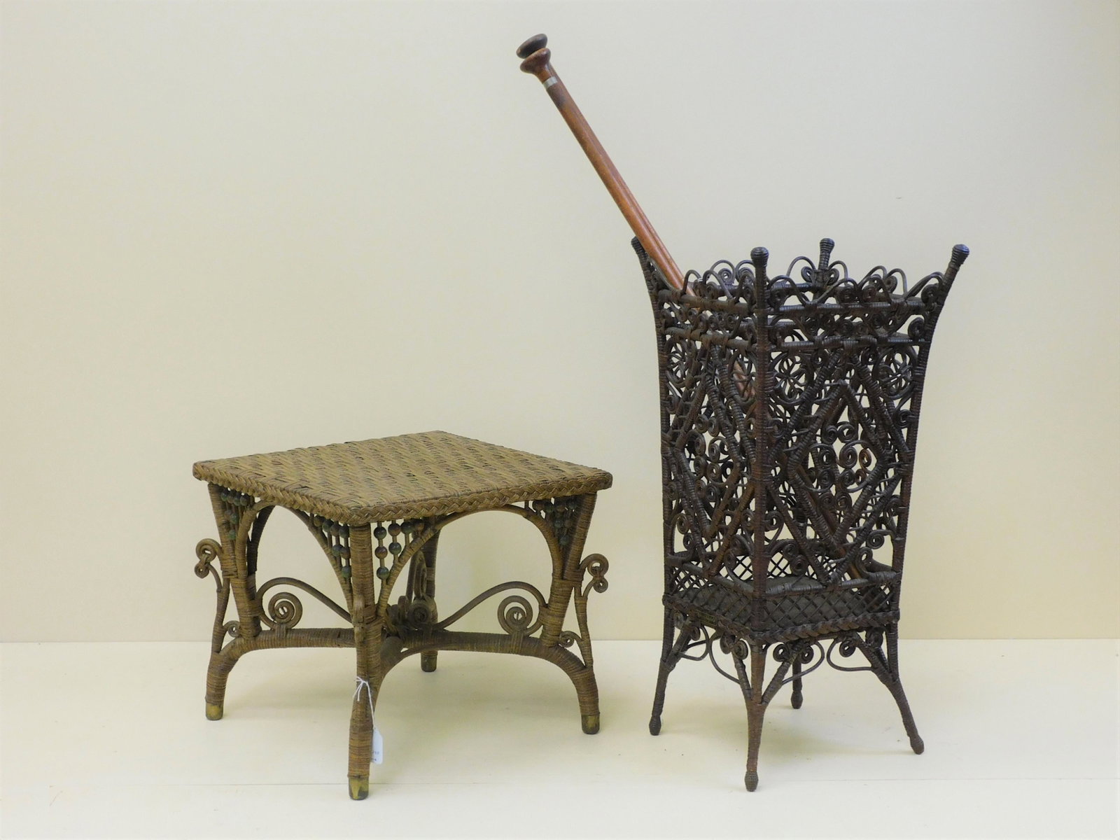 Victorian wicker plant and umbrella stand, late: 19th c. Natural finish, green painted beaded highlights. Fully woven top, arched beaded gallery and brass feet. 14 1/2" high, 17" wide, 17" deep. Overall good condition, has a light coat of polyuretha