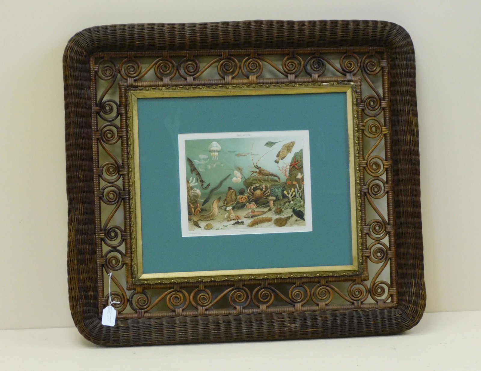 Rare Victorian wicker picture frame, late 19th c.: Natural finish, rolled edges with curlicue border. 27" high, 31" wide, 3" deep. Inset gesso gold border, possibly original, containing a colored lithograph titled "Aquarium". Overall good condition, s
