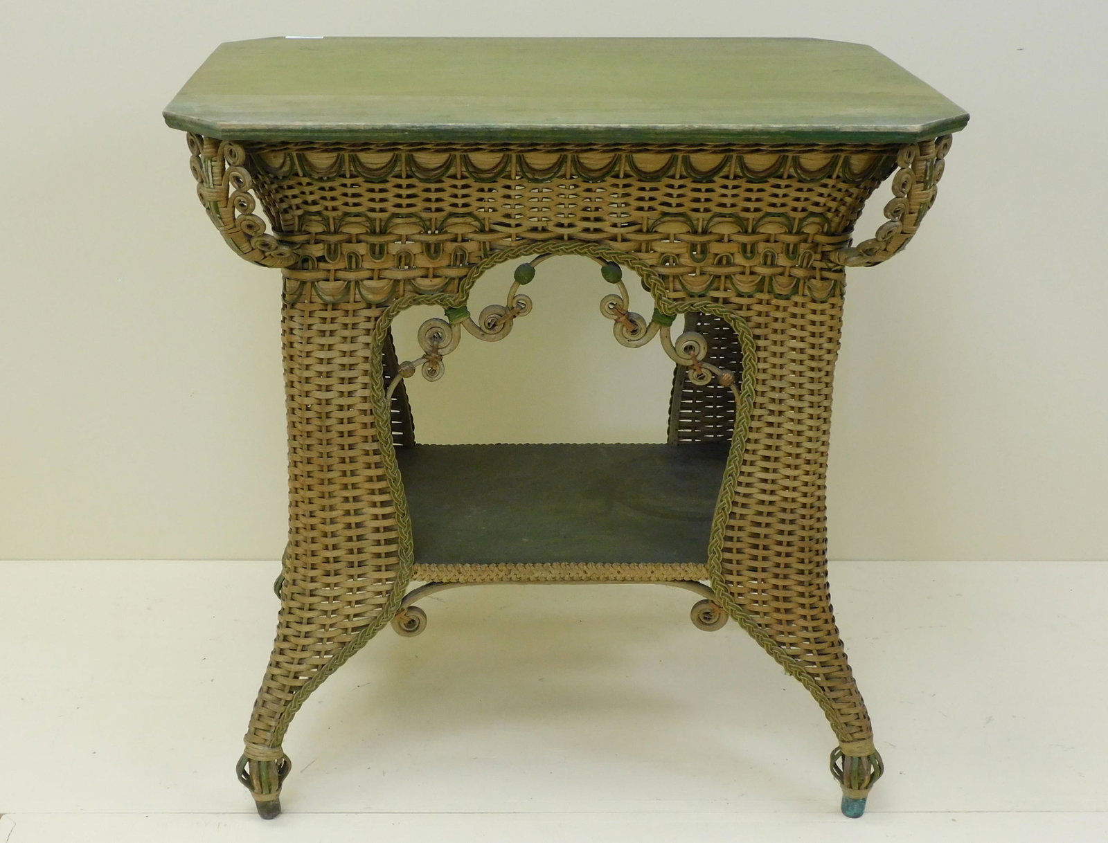 Victorian wicker table, Heywood Brothers and Co.,: ca. 1890. Rectangular top, with unusual tightly woven skirt, curved cabriole legs, birdcage design on feet. Original natural finish with green painted highlights and green stain on oak top. Retains it