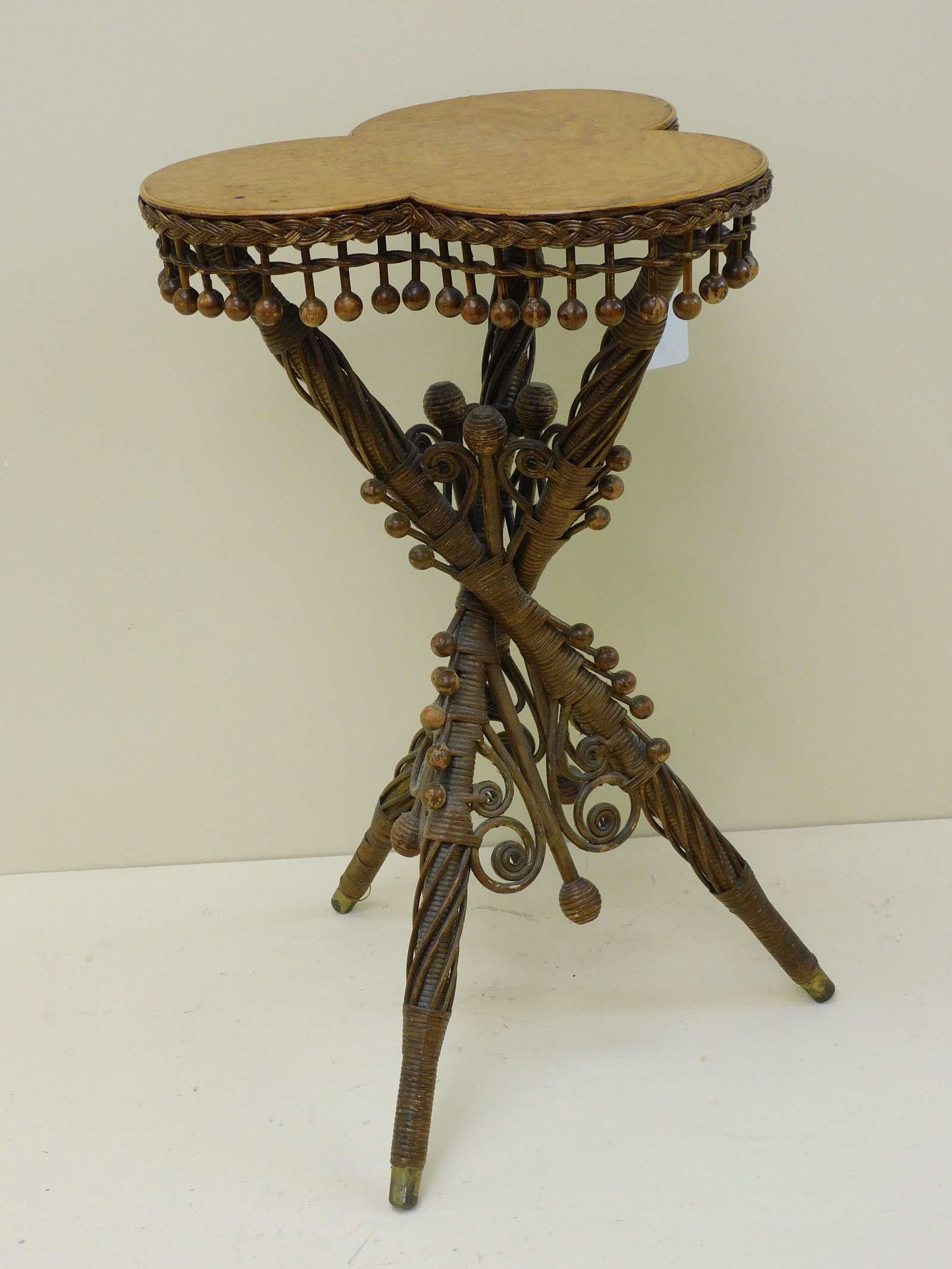 Rare Victorian wicker shamrock table, ca. 1890.: AA Tisdale Co., Leominster, MA. Shamrock shaped top, beaded gallery with tripod base, original finish with original label on underside. 28 1/2" high, 17" wide. Provenance: Mary Jean McLaughlin Collect