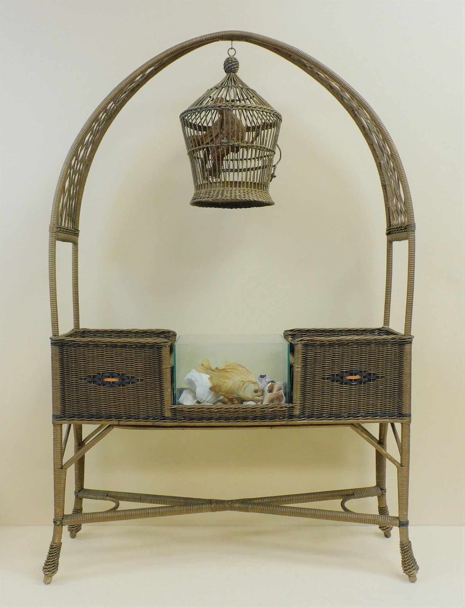 Art Deco wicker bird cage planter, ca. 1920.: Arched top with bird cage and wicker bird. Original factory paint with geometric black and orange geometric design, glass aquarium in center flanked by two compartments with metal inserts. 67" high, 4