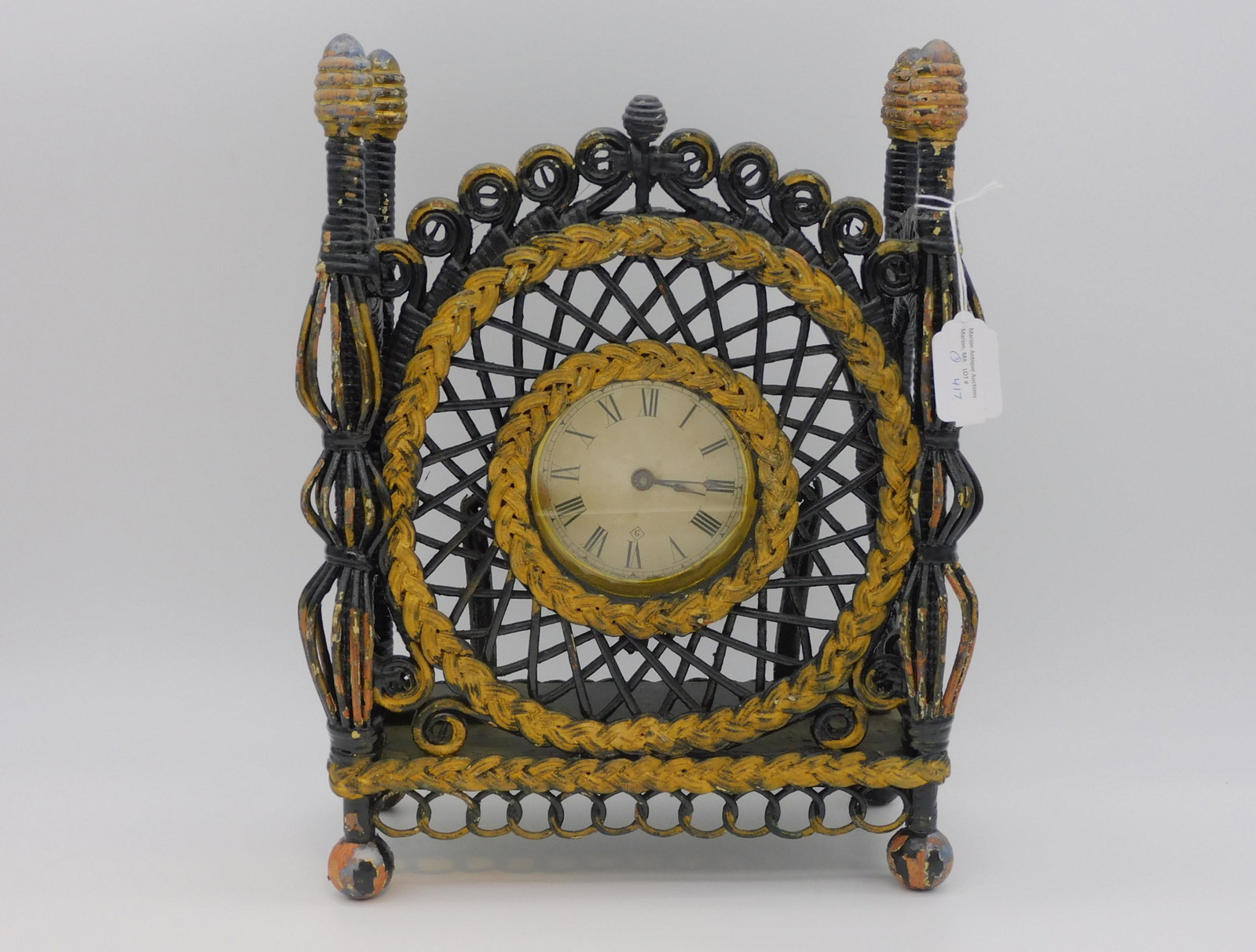 Rare Victorian wicker shelf clock, ca. 1895.: Gilbert Clock Co., CT. Ornate woven wicker case, old black and gold paint. 14" high, 10 1/2" wide, 5 1/2" deep. Paint shows chipping and wear. Along with a pair of wicker and gesso vases with applied 