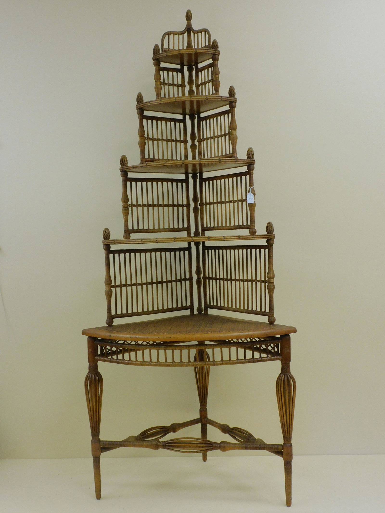 Victorian Heywood Brothers and Co. corner whatnot: shelf, extremely rare, ca. 1880s. Original natural finish. 5 graduated shelves, birdcage design on legs. Excellent condition, retains original factory label on underside of bottom shelf. 87" high, 35"