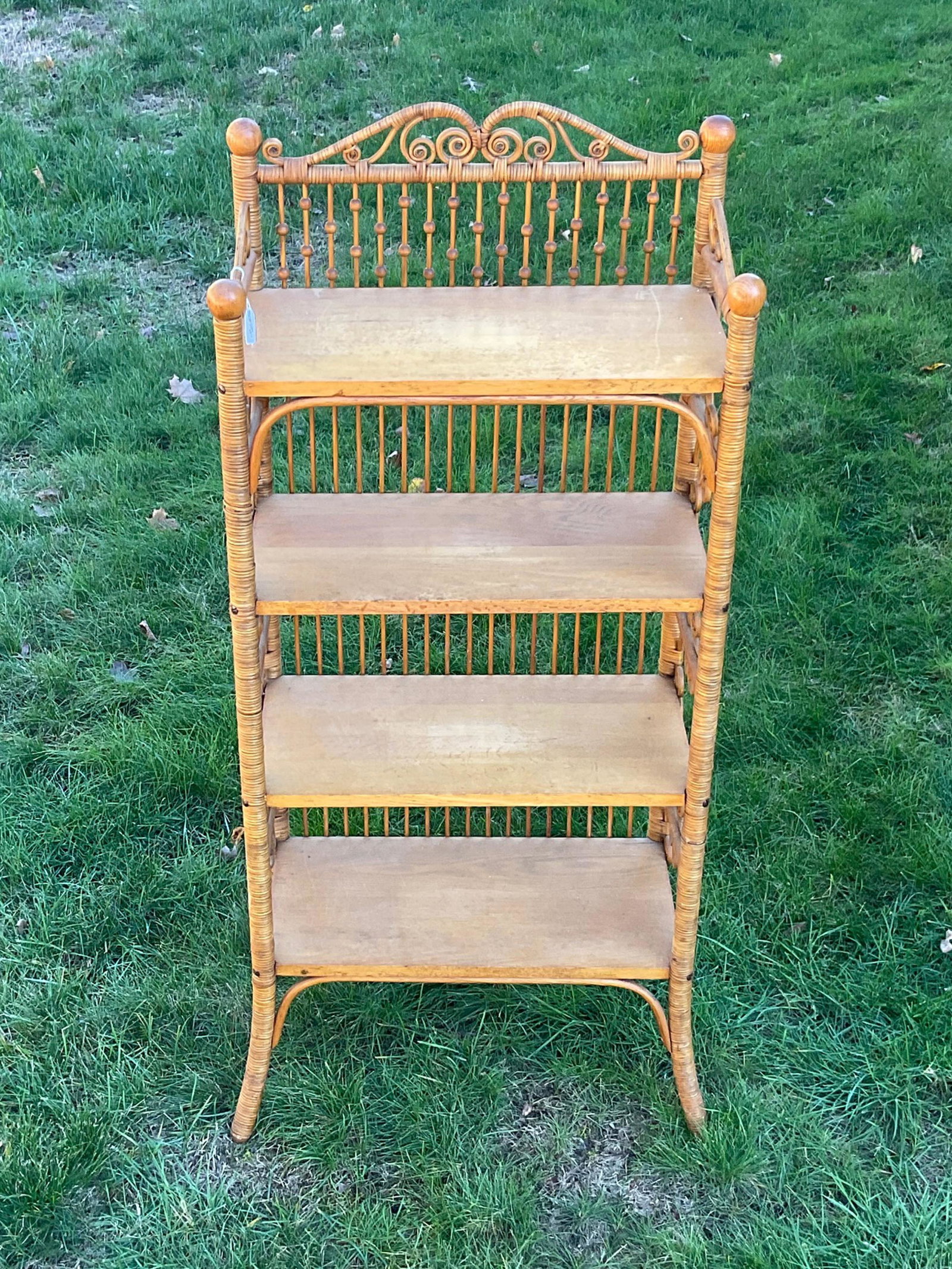 Victorian wicker etagere, ca. 1898. Oak shelves.: Curlicue and stick and ball decoration. Original natural finish. 58" high, 29" wide, 15" deep. Very good condition. Provenance: Mary Jean McLaughlin Collection.