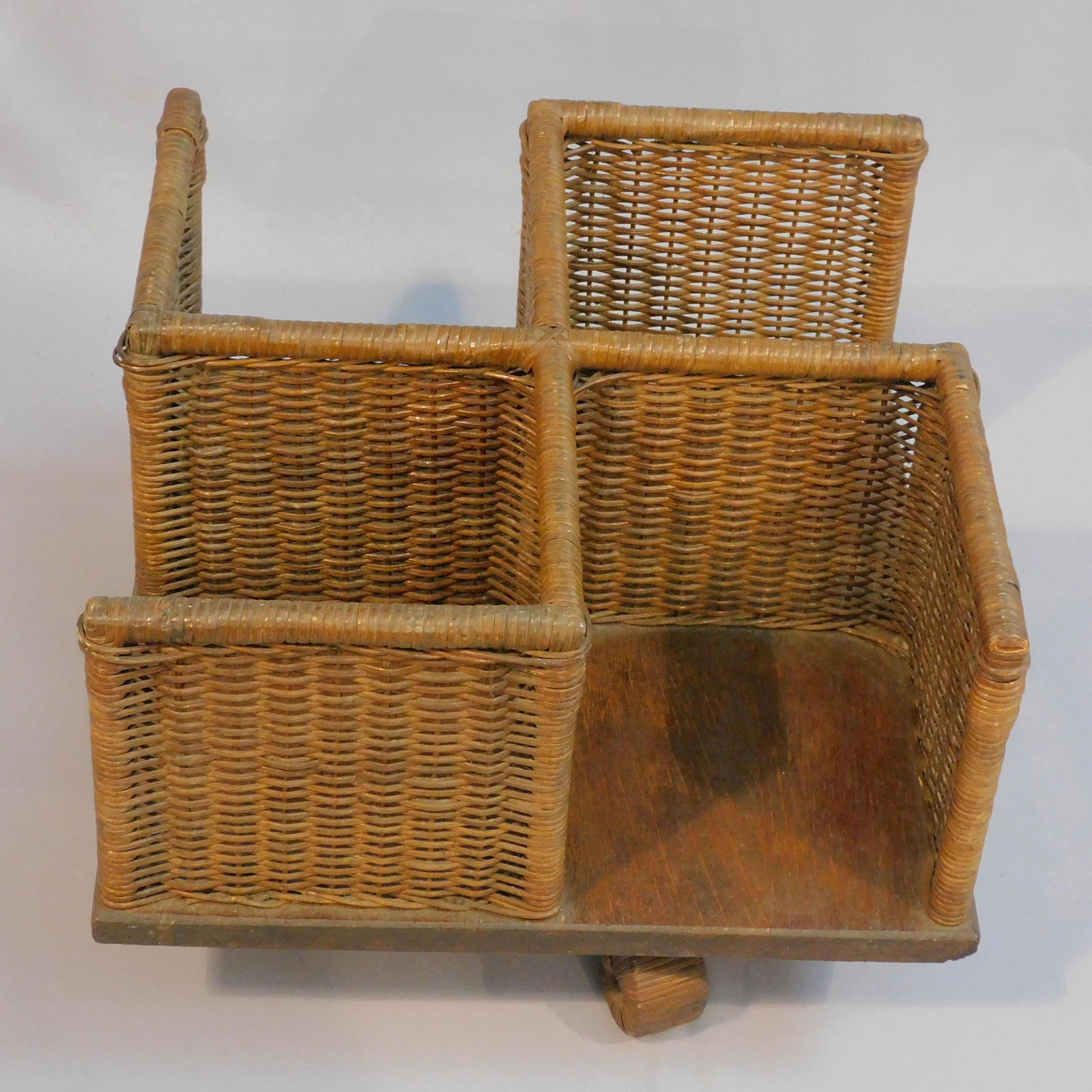 Wicker desktop revolving bookcase, ca. 1910. Arts: and crafts style, original natural finish with oak base. 11 1/2" high, 15 1/2" x 15 1/2". Good condition. Provenance: Mary Jean McLaughlin Collection.