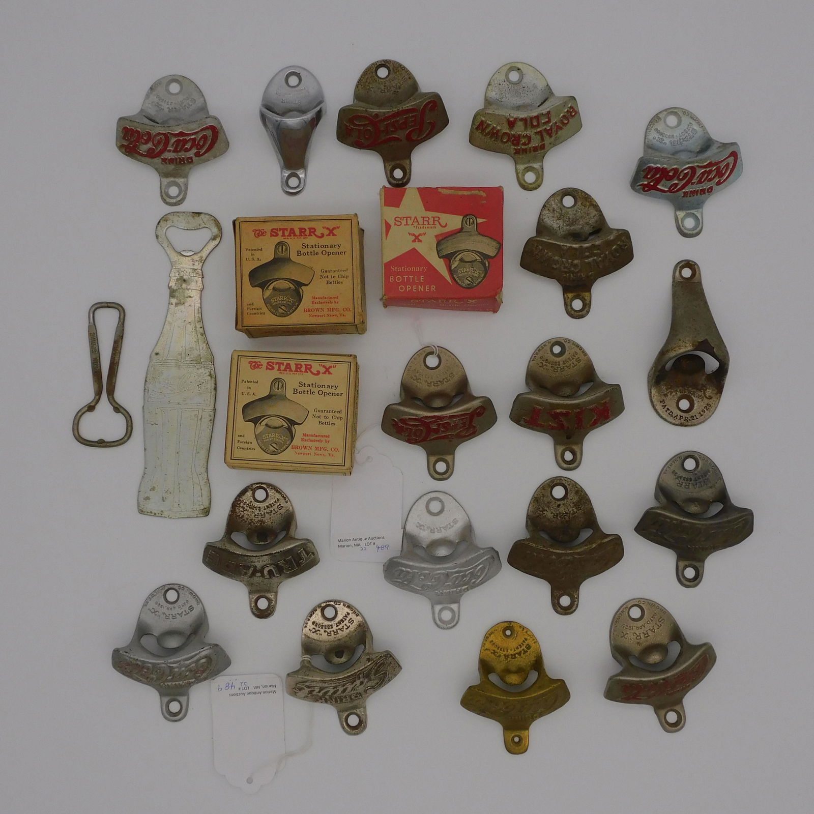(22) vintage bottle openers. To include: 8 Coca: Cola (one brass one could be a bit later), approx. 3". 2 Pepsi-Cola, 3". 2 Royal Crown, 3". 1 Squirt, 3". 1 Kist, 3". 1 Tru-Ade, 3". 2 Starr, 2" wide. 1 Simpson Spring, 3 3/4" wide. 1 Coke bottle form