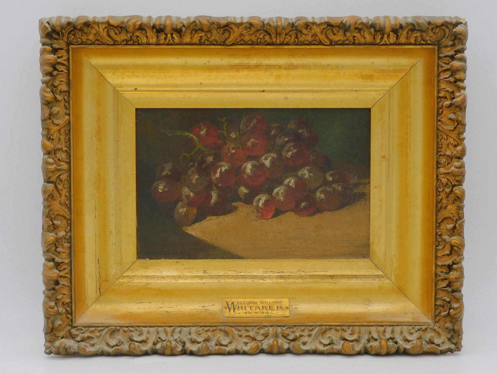 George Whitaker (1841-1916, RI, NY, MA) still: life of grapes. Late 19th-early 20th c. Oil painting on canvas, signed lower left. In a period ornate carved and gilded frame. Sight size 6" x 9", overall 12" x 15". The painting is in untouched origi