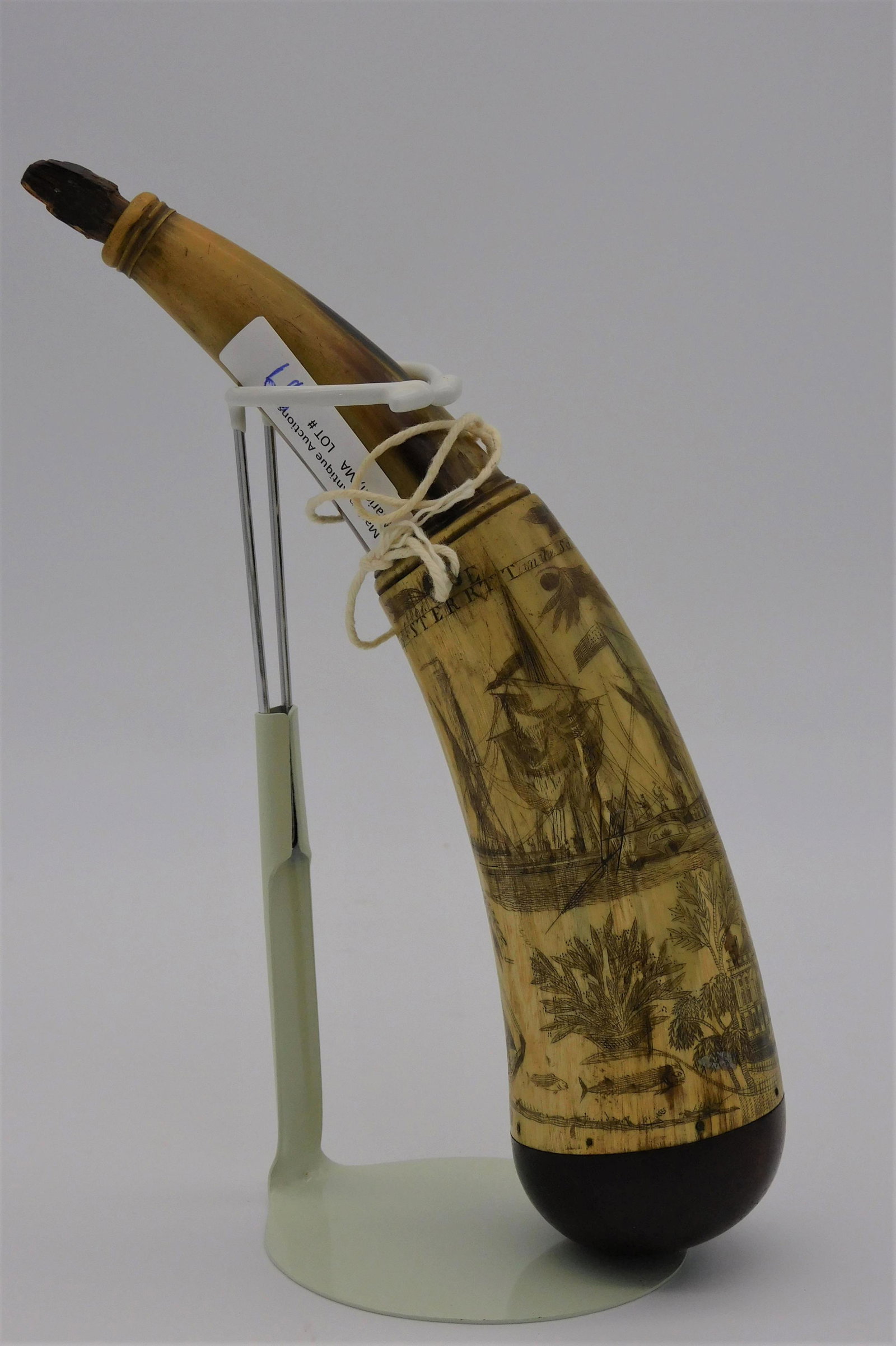 Rare and unusual engraved powder horn.: Elaborately engraved powder horn with images of eagles, fish, palm trees, cornucopia, a naval battle scene from The First Barbary War titled (Capt. Sterrett in the Schnr. Enterprise paying tribute to 