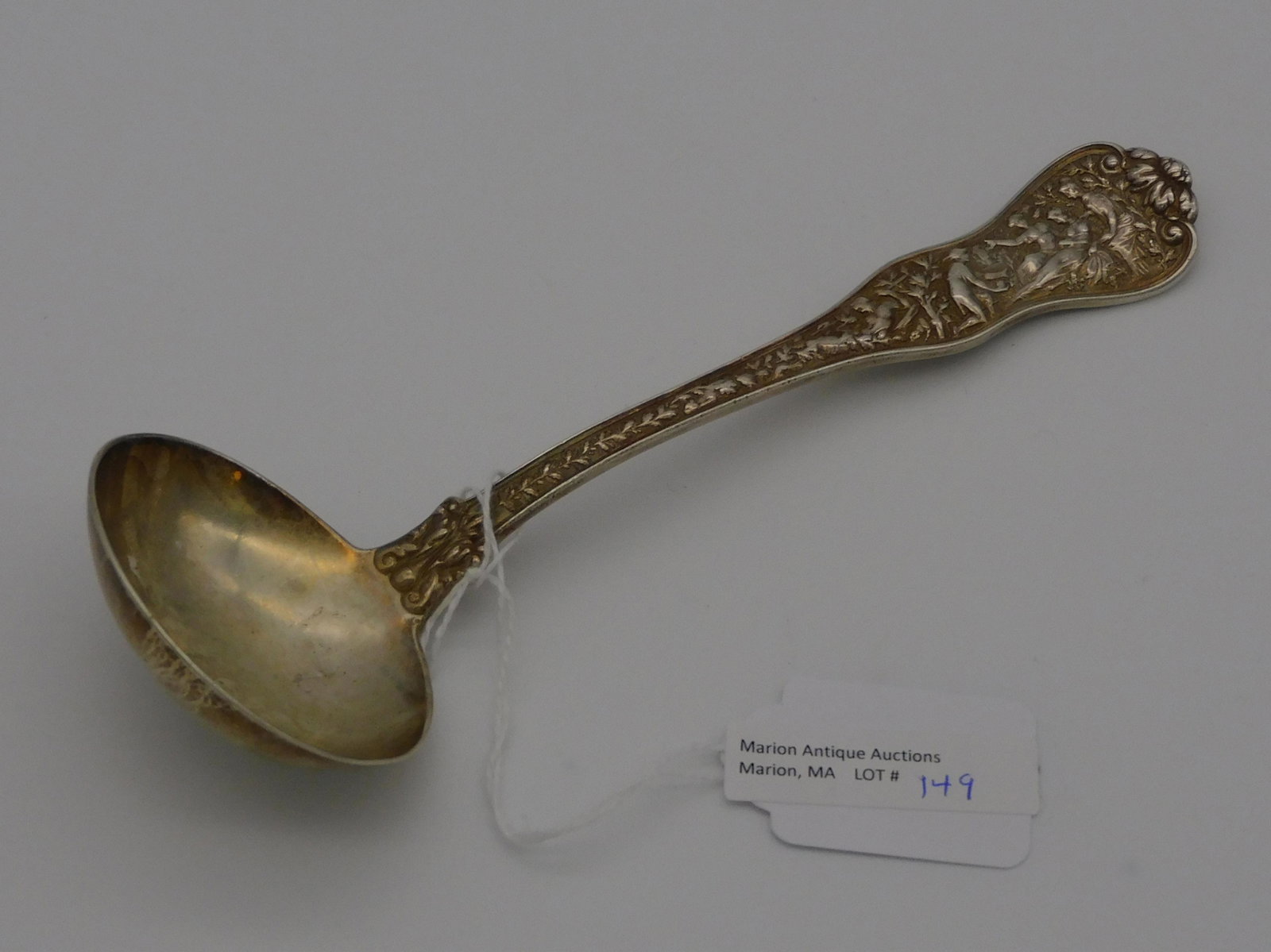 Tiffany silver ladle, 1878. Sterling silver in: the Olympia pattern with a monogram on the back. 3.85 ozt. 7 1/2" long. Good condition.