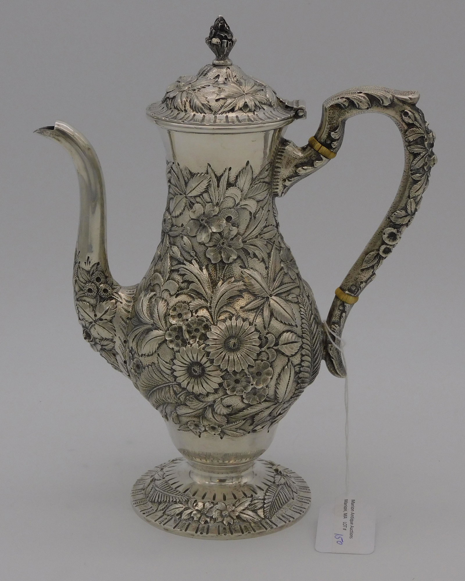 S. Kirk and Son sterling silver coffee pot, late: 19th century. It has an elaborate floral repoussé design. Marked on bottom 925/1000 # 184. 18.19 ozt. 10" high, 8" wide. It is in good original condition with a slightly loose handle.
