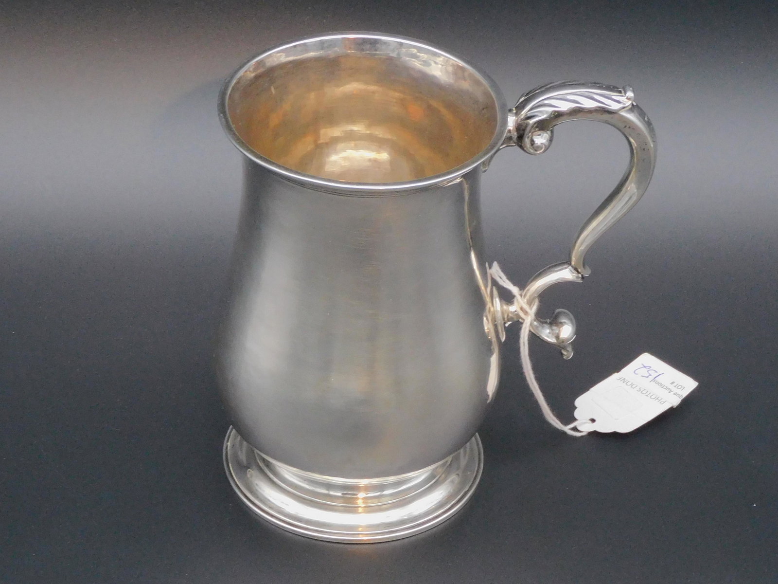Silver cann by Zachariah Brigden. (1734-1787): Brigden was born in Charlestown, MA and worked in Boston, MA. Marked on bottom. Acanthus leaf scroll handle. Approx. 6" high, 5 1/2" wide, 3 3/4" diameter. 13.27 ozt. This tankard is marked S H M on t