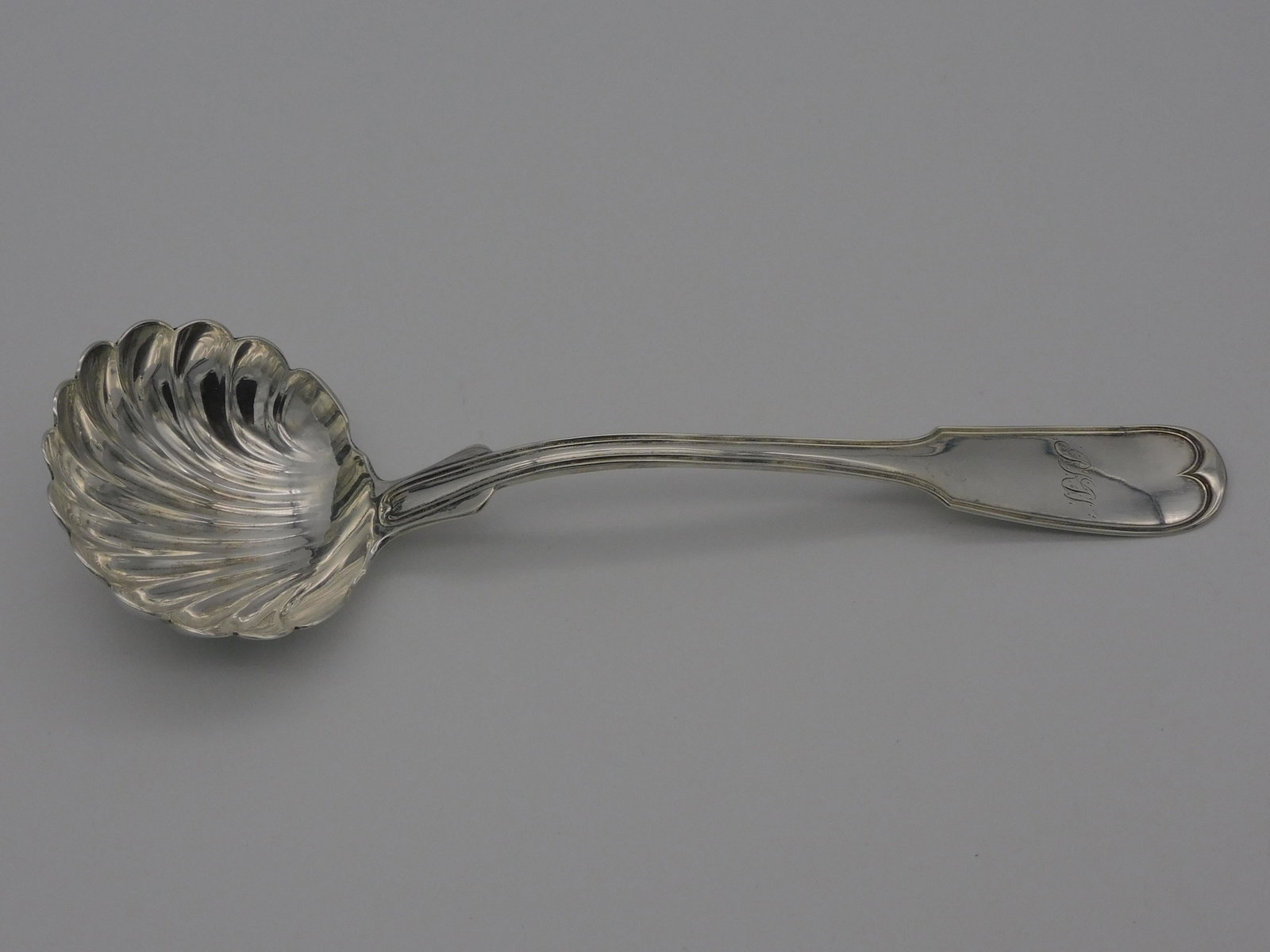 R.W. Wilson coin silver ladle, early 19th c.: Fiddlehead top with a shell form bowl. Monogrammed. Made in Philadelphia. 4 ozt. 11" long. Excellent condition.