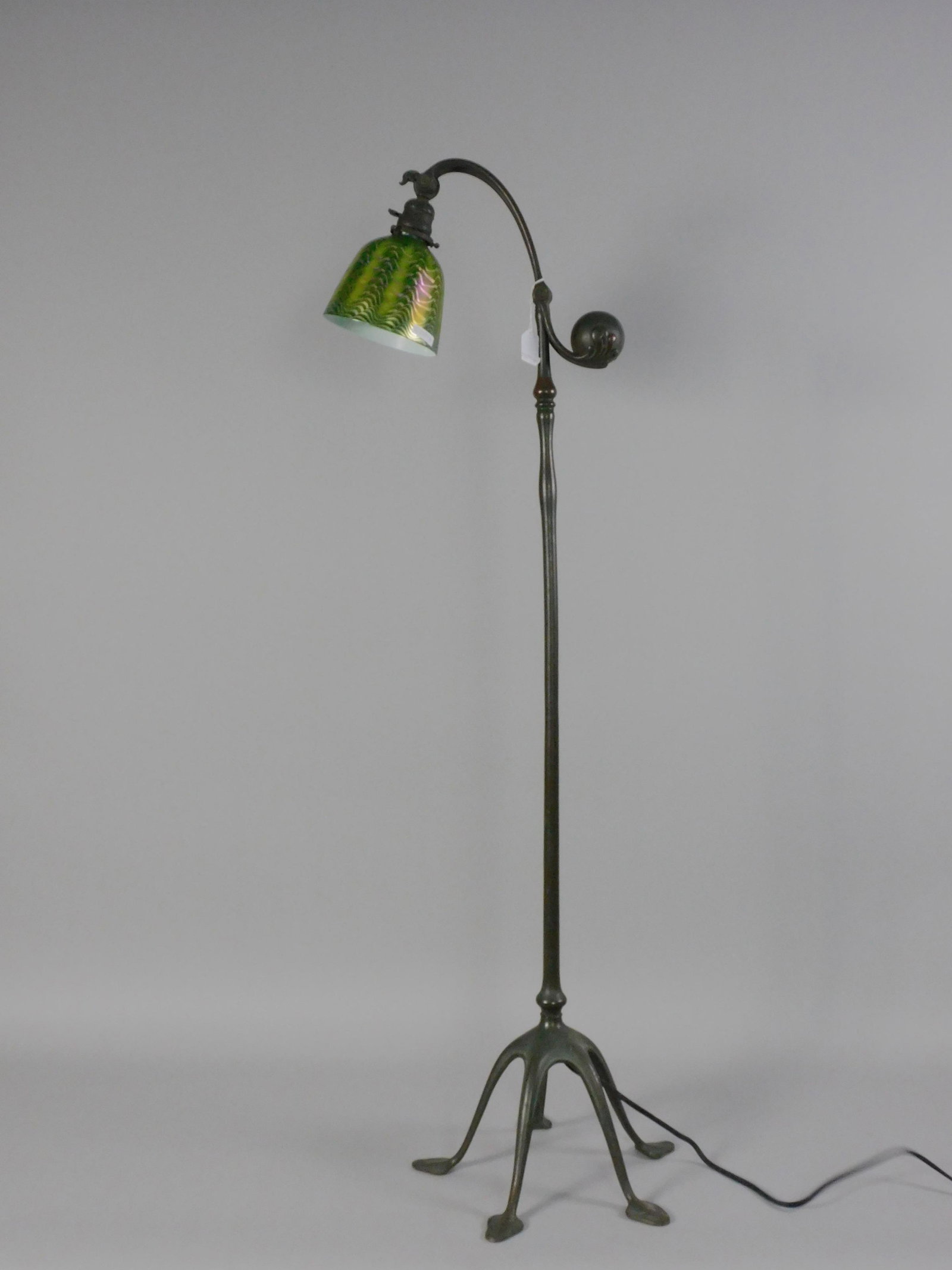 Tiffany Studios counterbalance floor lamp. Early: 20th century. With a green cased art glass shade. Signed Favrile on rim. The base is marked Tiffany Studios, New York # 468. The lamp retains its original socket with a ratchet mechanism. Original bro