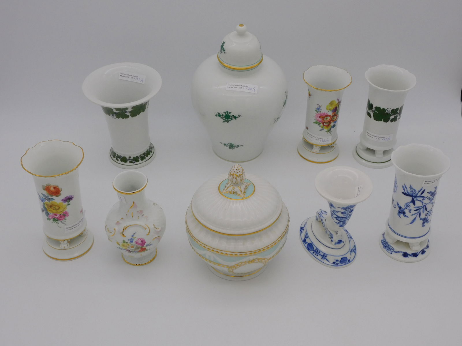 (9) pieces of Meissen, KPM, and Vienna porcelain.: Early 20th c. 7 cross sword, Meissen vases with various hand-painted designs, 4 3/4" to 5 3/4" h. KPM covered bowl with gilt fruit finial. 6" high, 5" deep. Royal Vienna covered urn with green floral