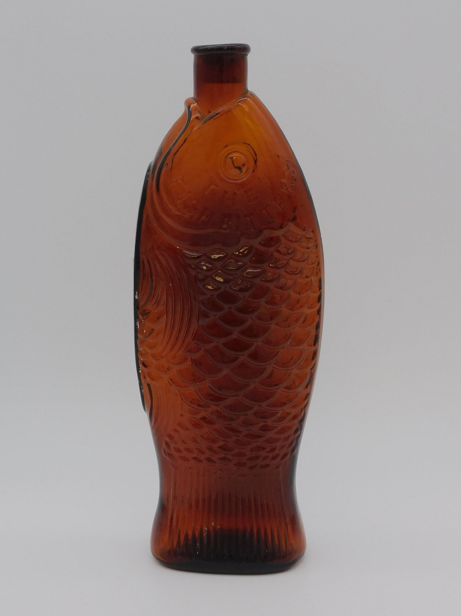 W. H. Ware patented 1866 The Fish Bitters bottle.: Amber, 11 1/2" high. Rolled applied lip. No visible damage.