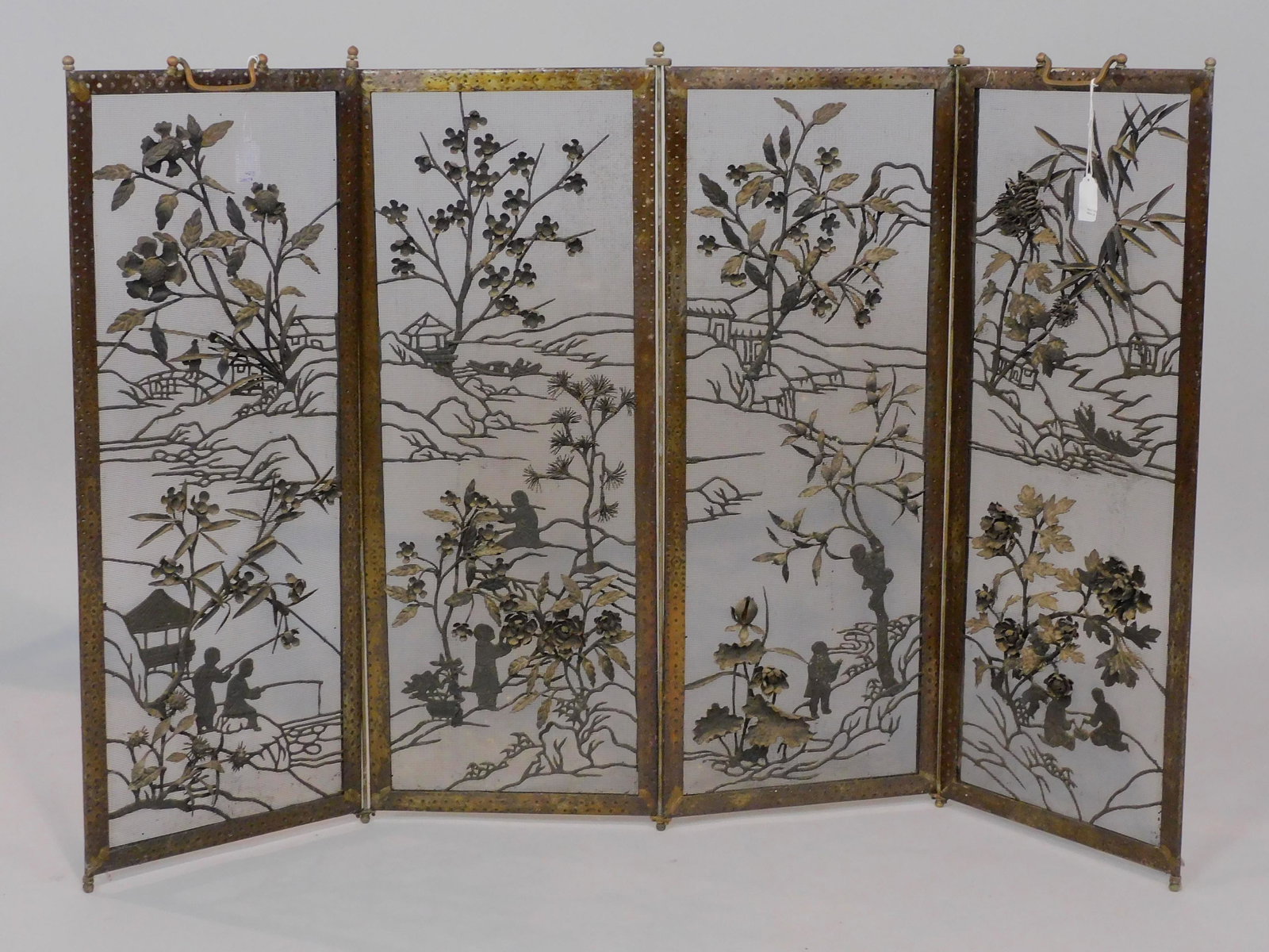Arts and Crafts fire screen, ca. 1920. A wrought: iron 4 paneled folding fire screen in a Japonisme style. 31" high, each panel is 30" x 12". Shows some wear to finish good overall condition.