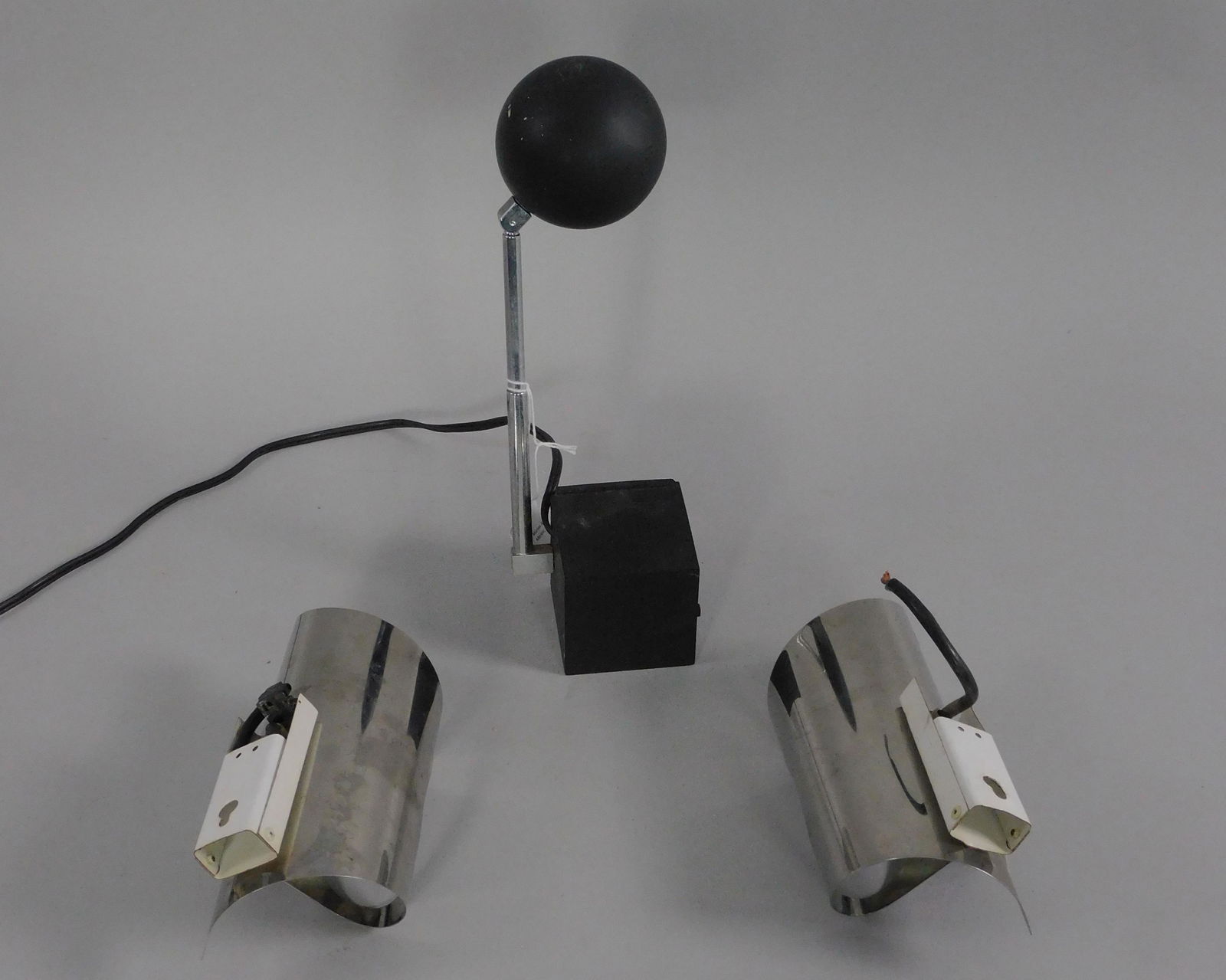 Mid-Century Modern lighting lot, to include: 1): Michael Lax for Lightolier, Black Lytegem desk light, made in Japan, 1965. 11 1/2" high, 4" wide, 3" deep. 2) a pair of chrome continental wall sconces, ca. 1970s. 4" high, 7 1/2" wide, 4" deep.