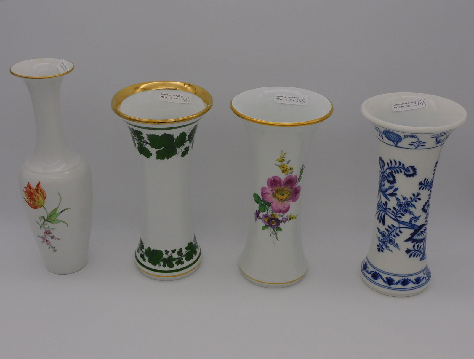 (4) Cross Sword Meissen and KPM porcelain vases.: 19th c. To include: three Meissen flared rim vases, 9 3/4" high, blue onion, green ivy, and floral decoration. One shows a minor nick to the rim. Along with a KPM vase, floral decoration, urn shaped,