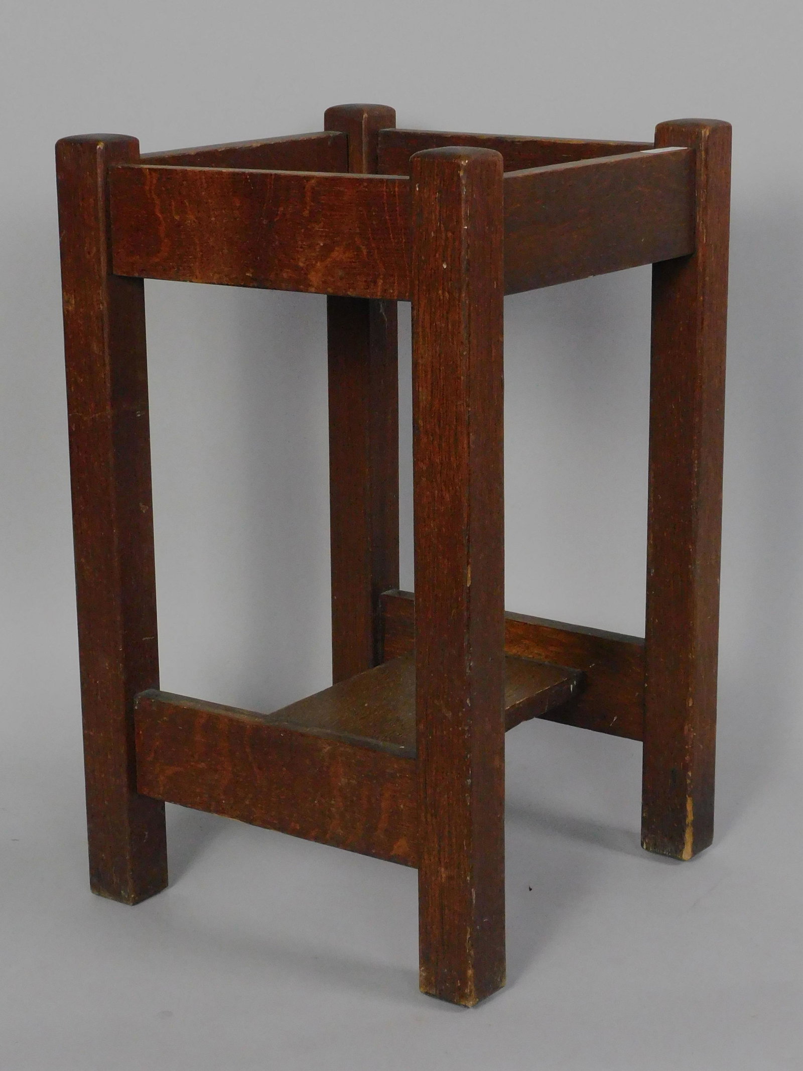 L & J G Stickley plant stand, ca. 1910.: Quartersawn oak, original finish. Label on underside of bottom shelf. Shows slight discoloration to finish on top shelf. Age appropriate wear. 22" high, 13 1/2" x 13 1/2".