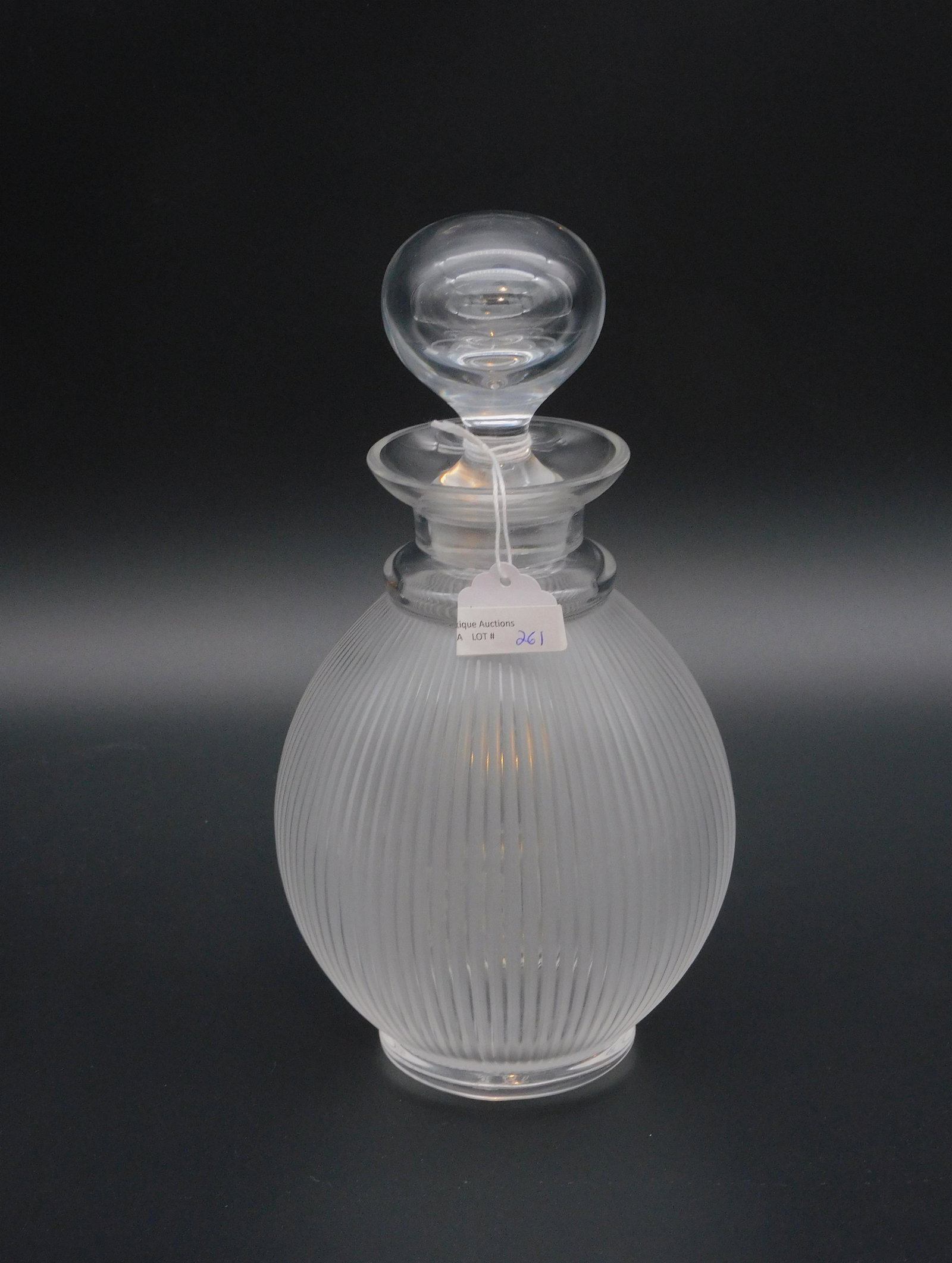 Lalique decanter, 20th c. Signed on bottom: "Lalique France". Frosted ribbed design. With original stopper. 7 1/8" high, 10" high with stopper, 3" base diameter. Excellent condition.