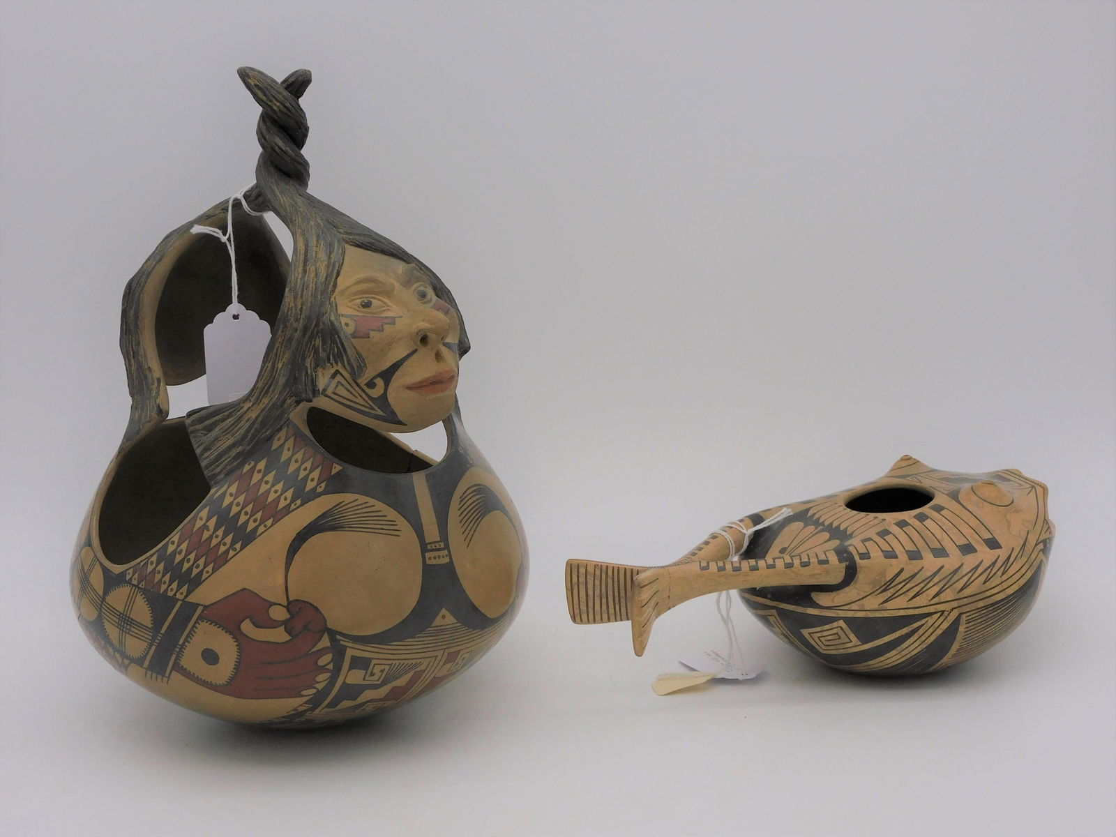 Nicolas Ortiz pottery, Casas Grandes, Janus face: vessel, Native American figural heads. Signed on base. Shows small crack, possibly a result of firing, approx. 1". Along with a frog form vase, also by Ortiz, shows slight hairline to tail.